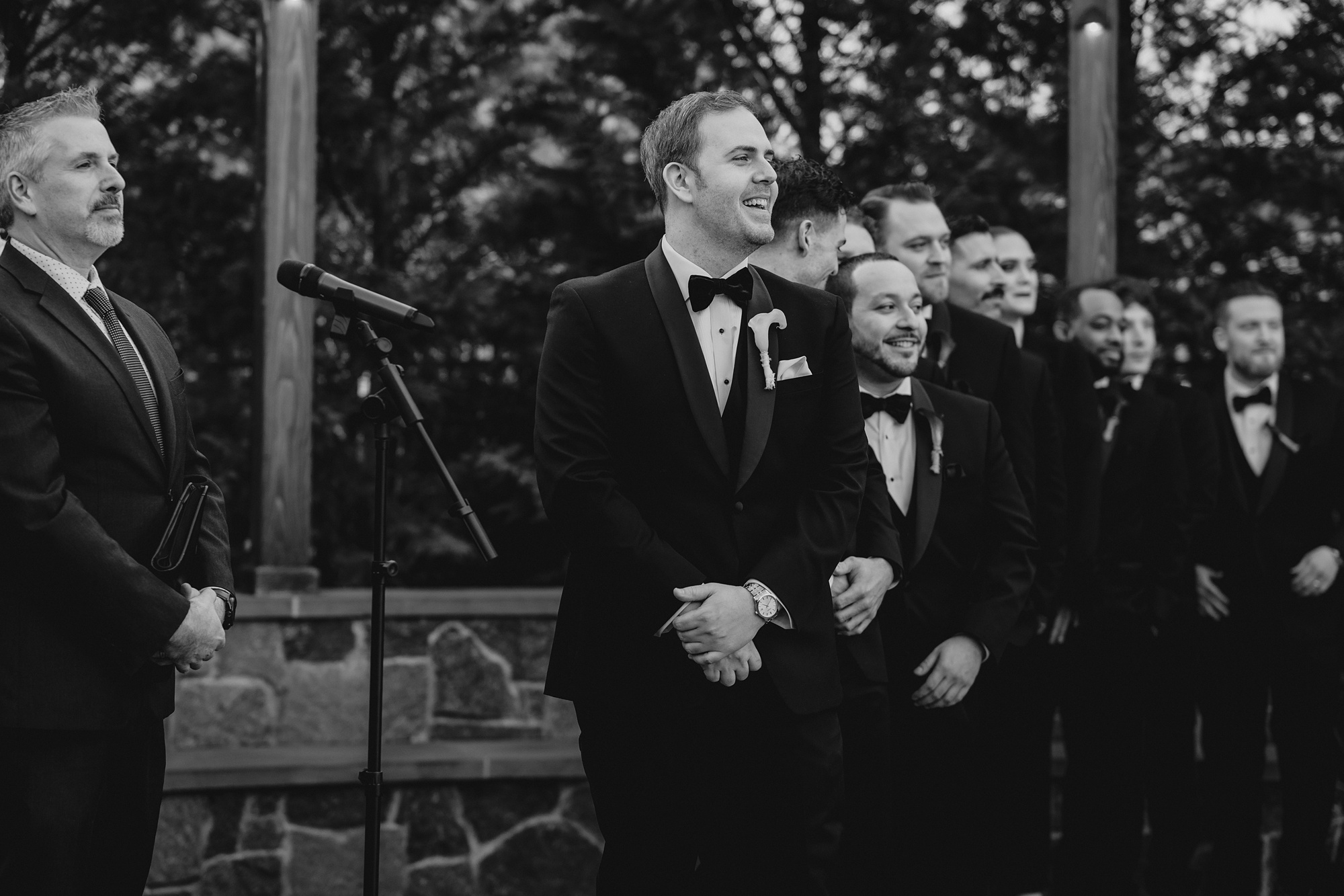 groom watches bride in aisle during winter wedding ceremony outside at David's Country Inn