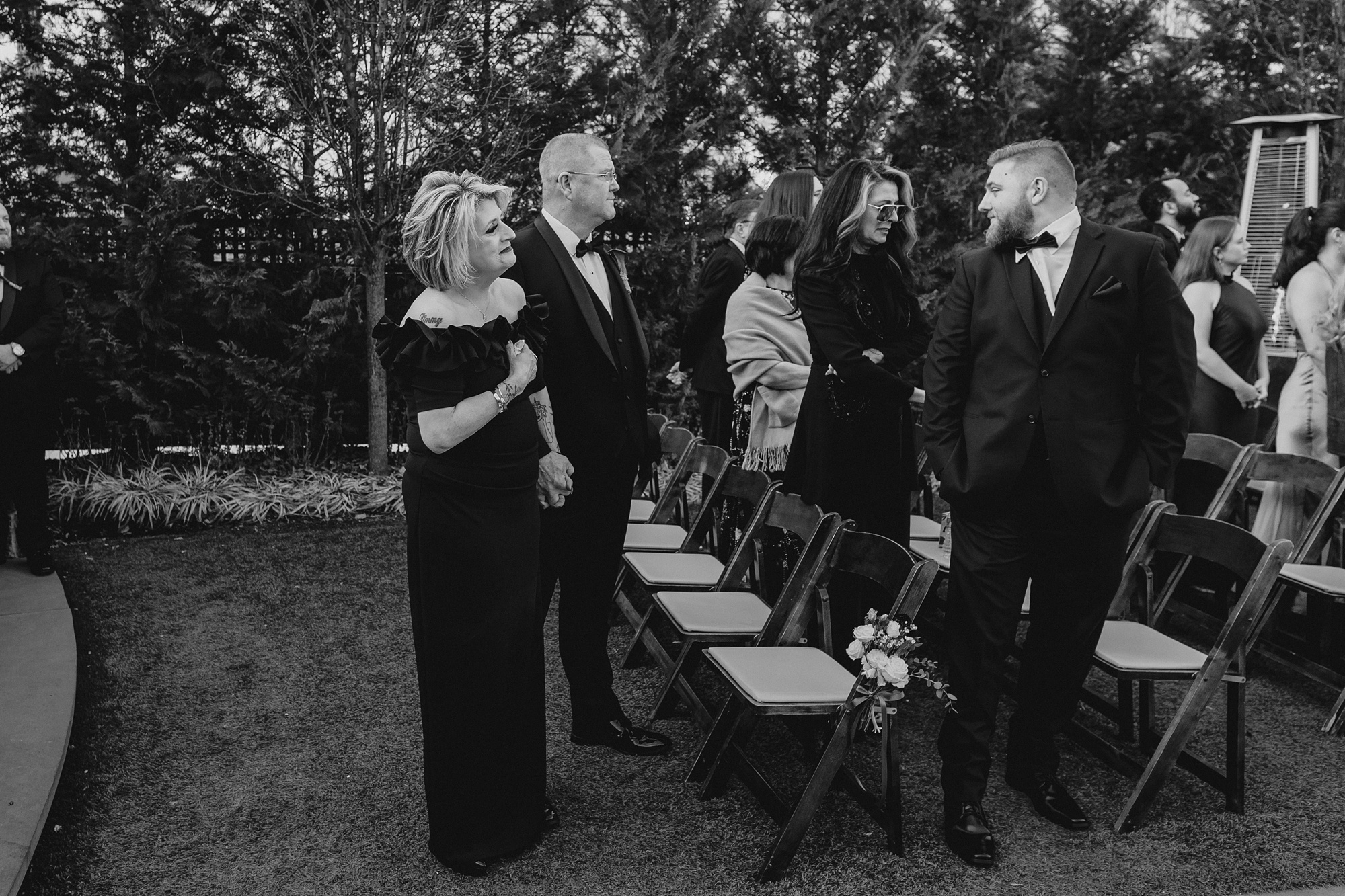 parents and guests watch aisle during winter wedding ceremony outside at David's Country Inn