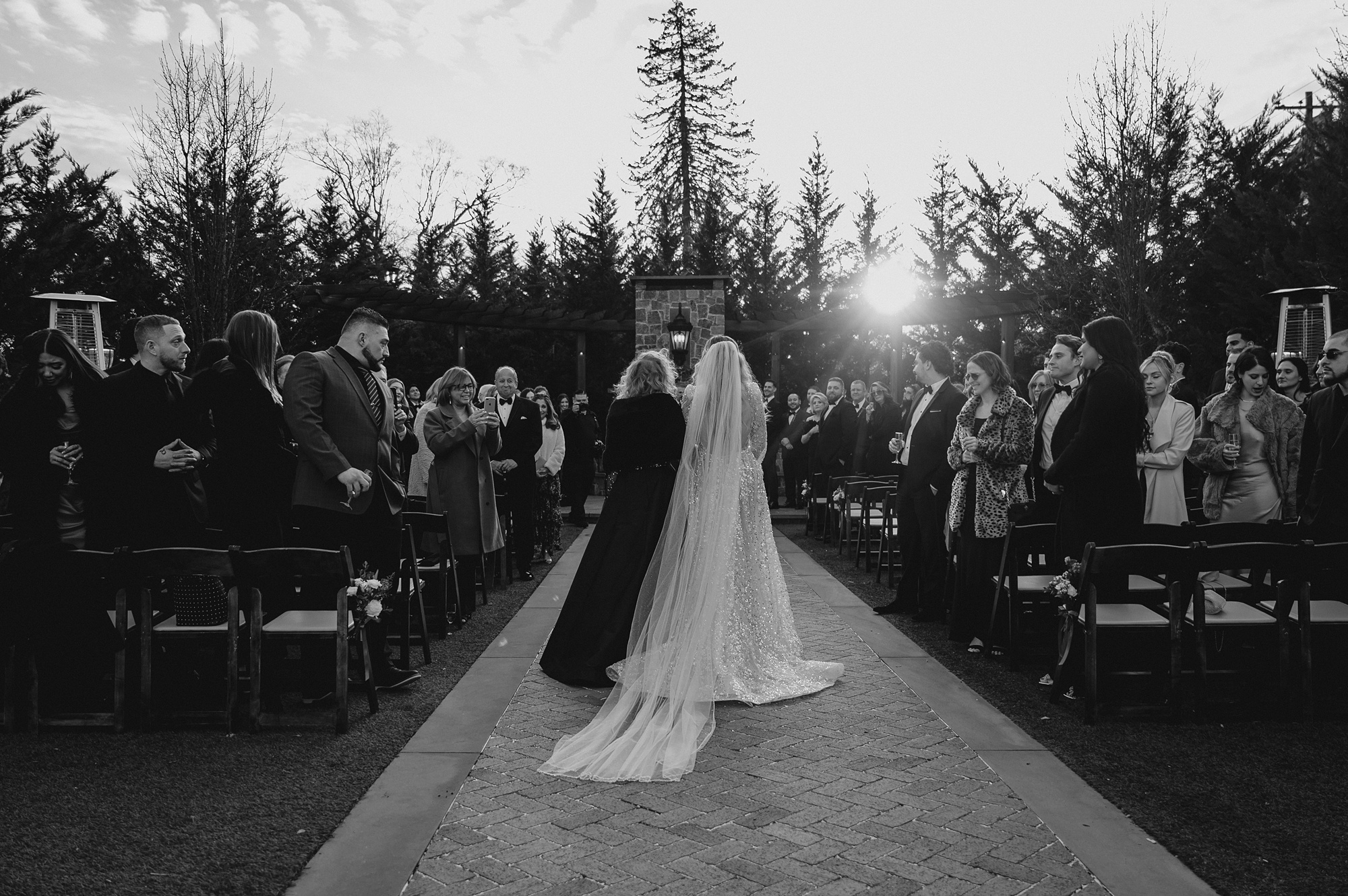 mother walks bride down aisle for winter wedding ceremony outside at David's Country Inn