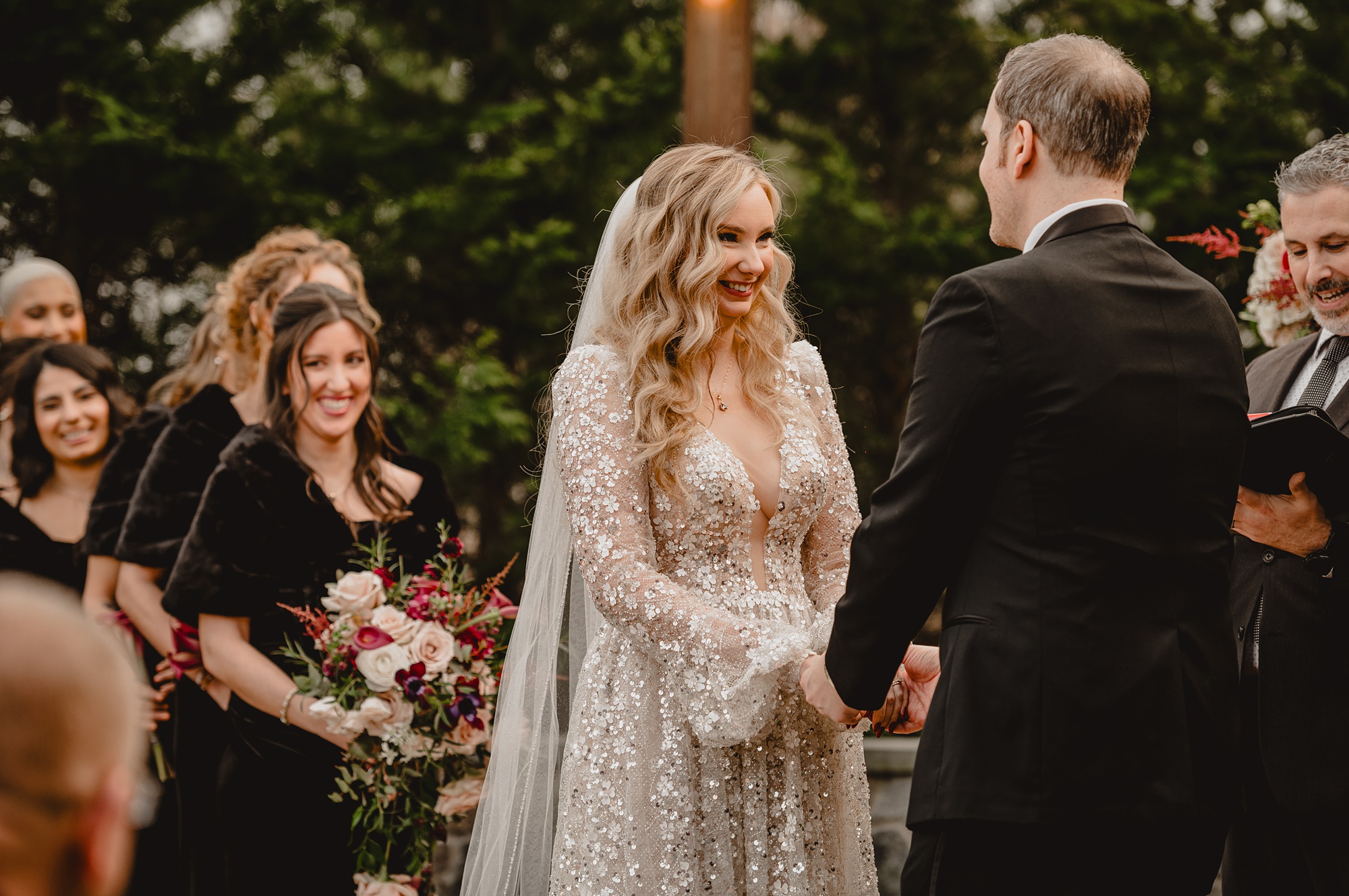 bride smiles at groom during wedding ceremony