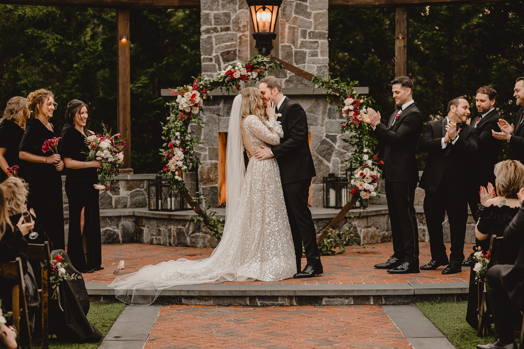 newlyweds kiss by brick fireplace at David's Country Inn