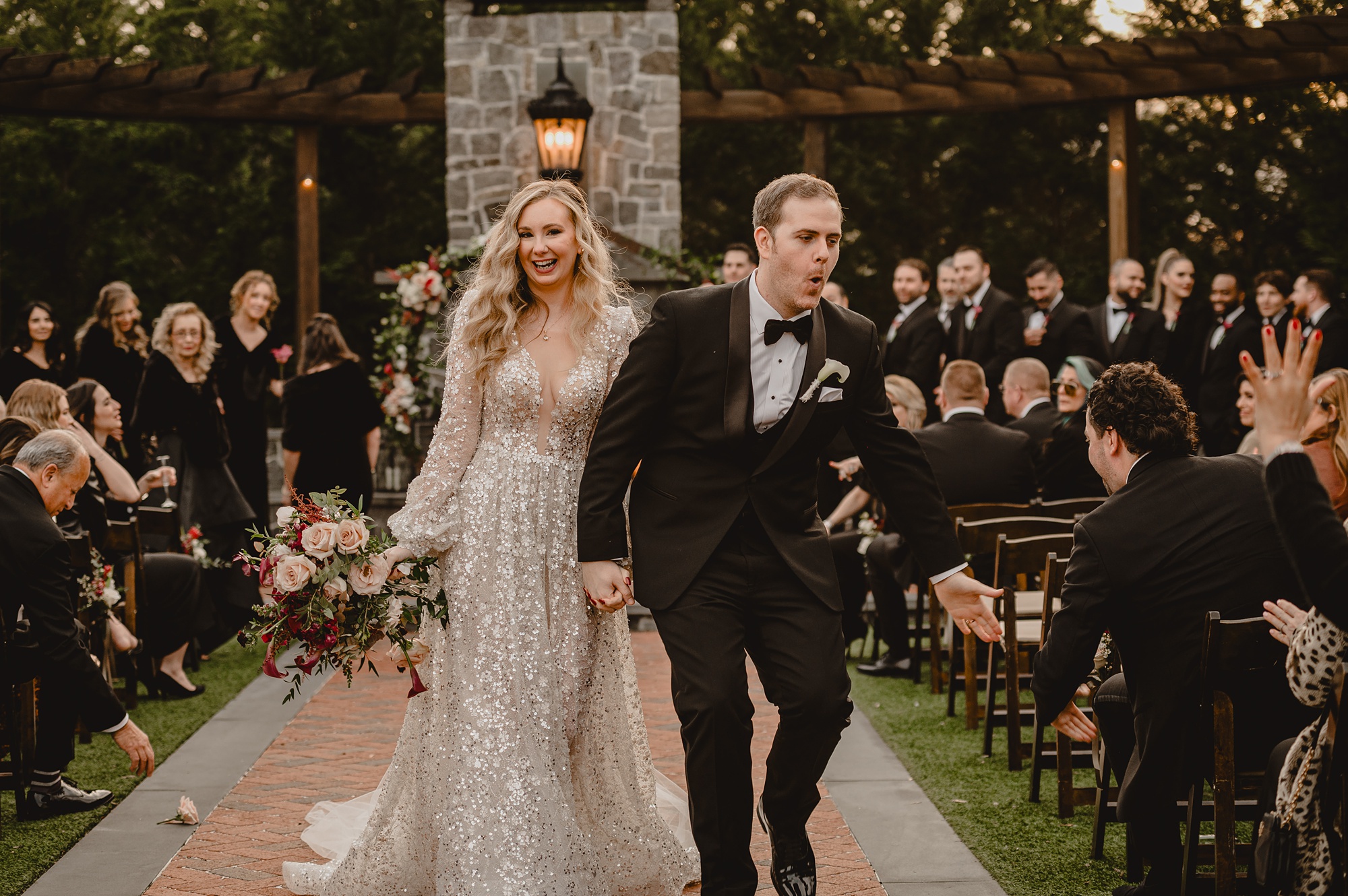 bride and groom laugh walking up aisle after ceremony