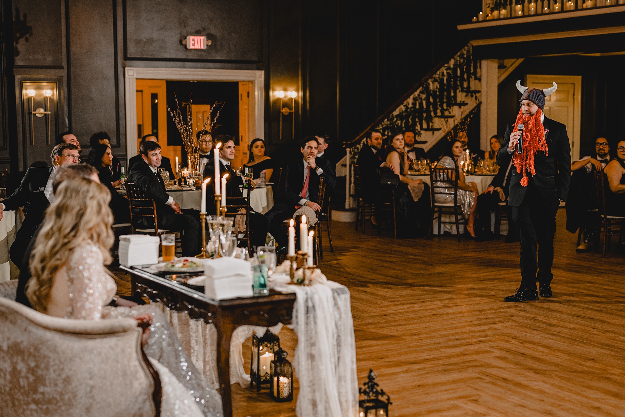 groomsmen gives speech wearing viking hat and beard