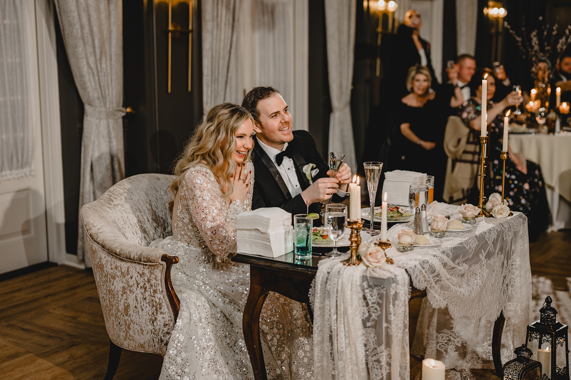 bride and groom listen to speech during NJ wedding reception
