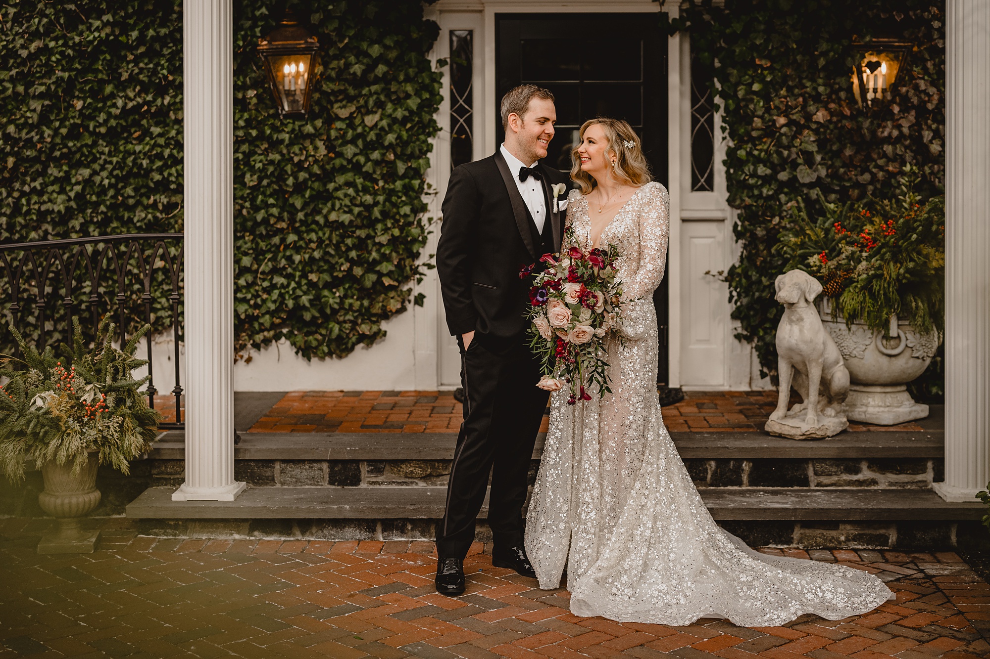 bride and groom stand in front of David's Country Inn on wedding day