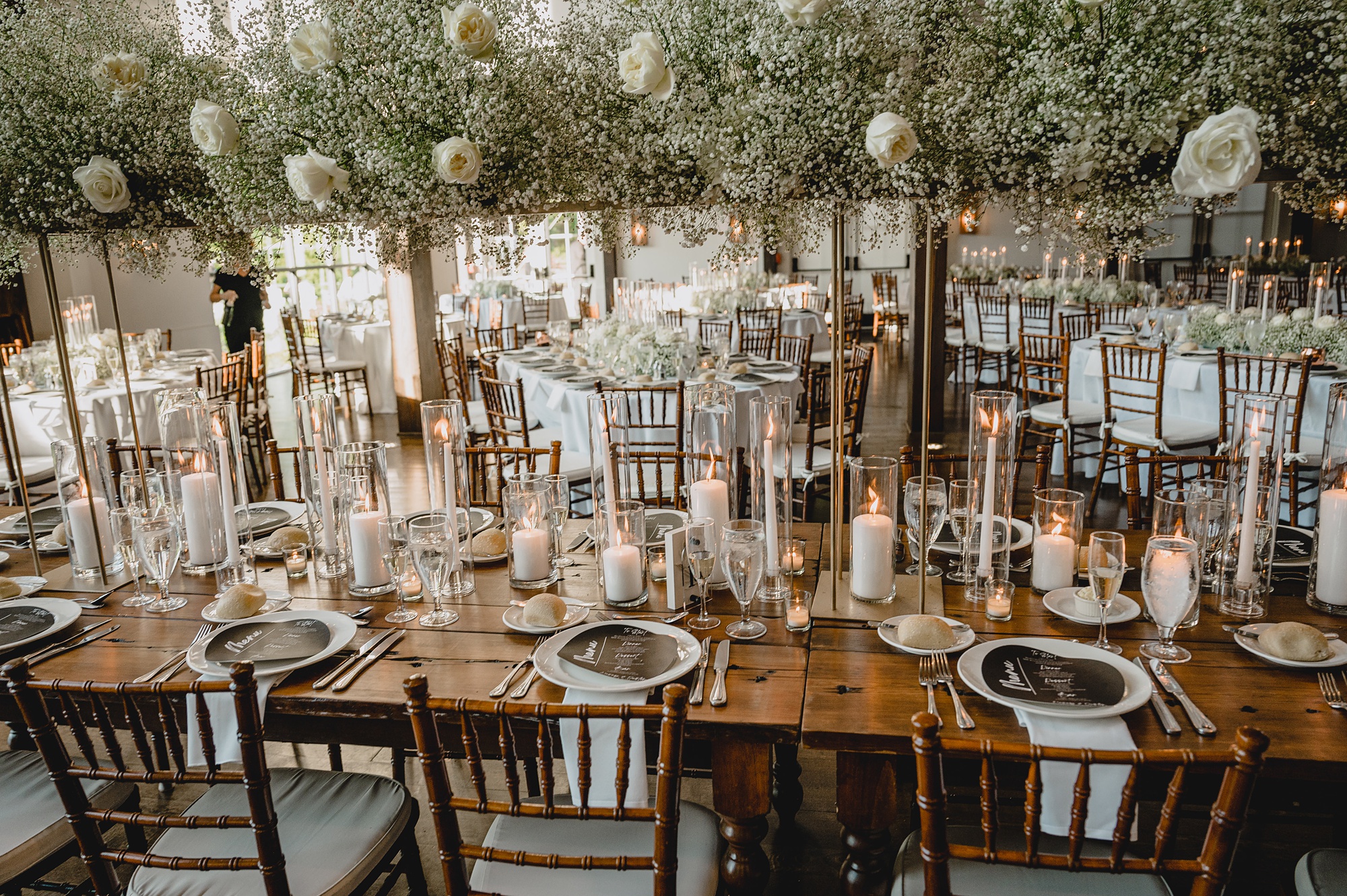rustic reception table at Crossed Keys Estate with white candles and gold accents