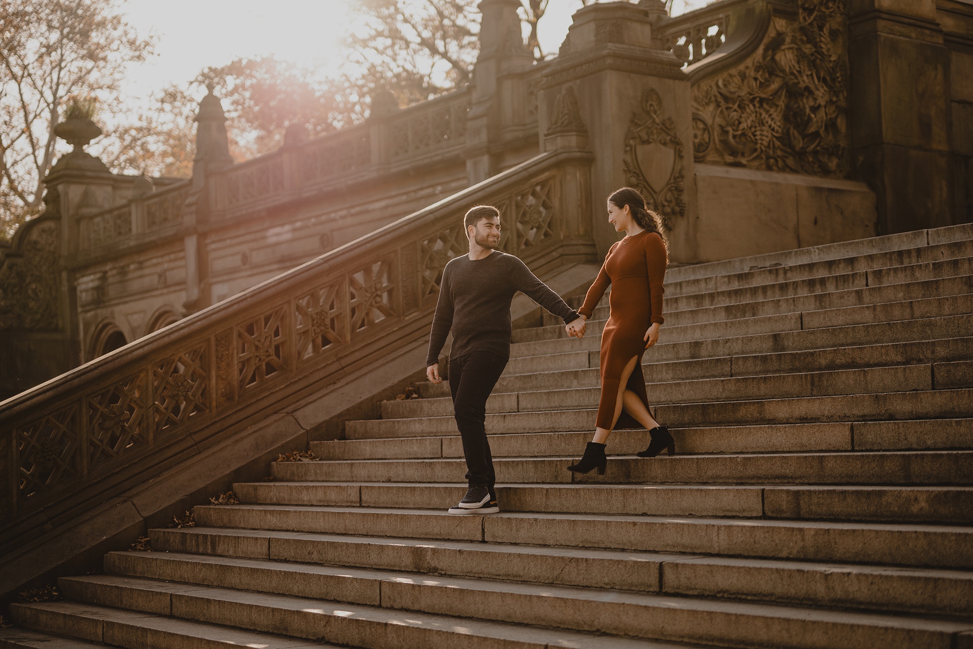 man leads woman down staircase inside Central Park