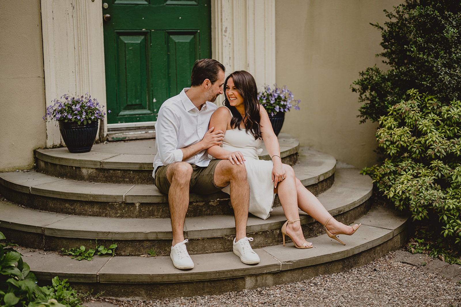 engaged couple sits on steps of historic home in New Jersey 