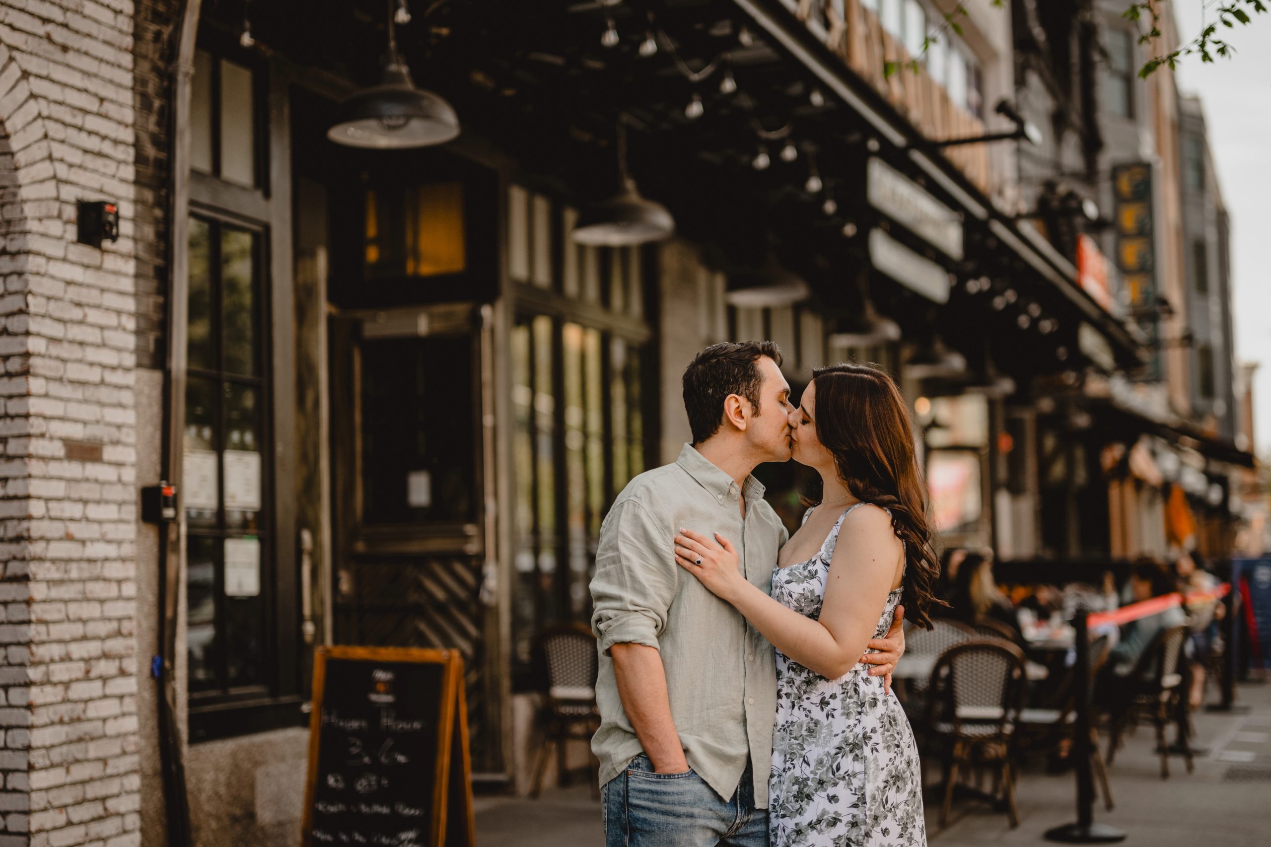 engaged couple kisses on street in New York City