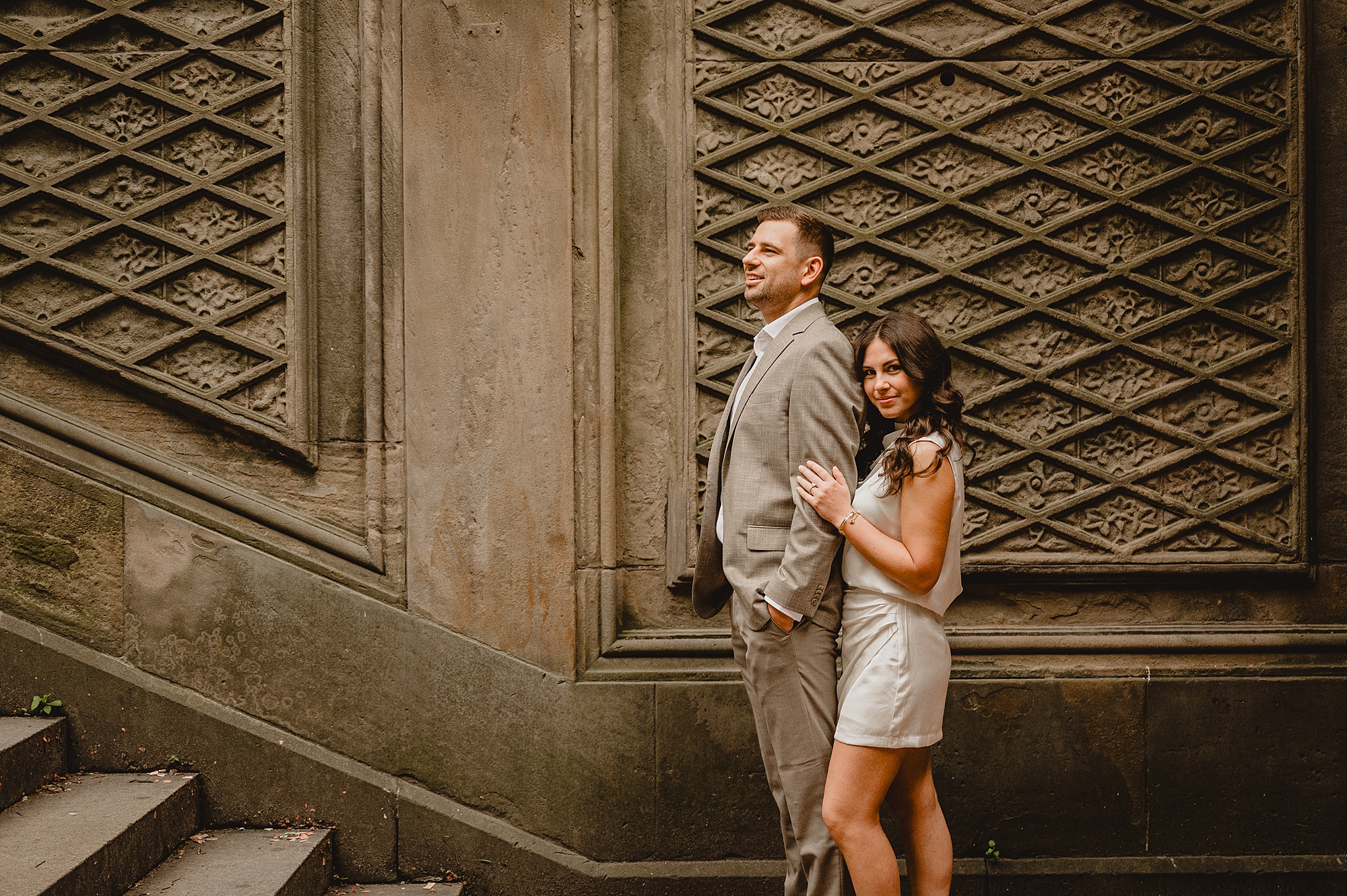 woman hugs man from behind on steps 