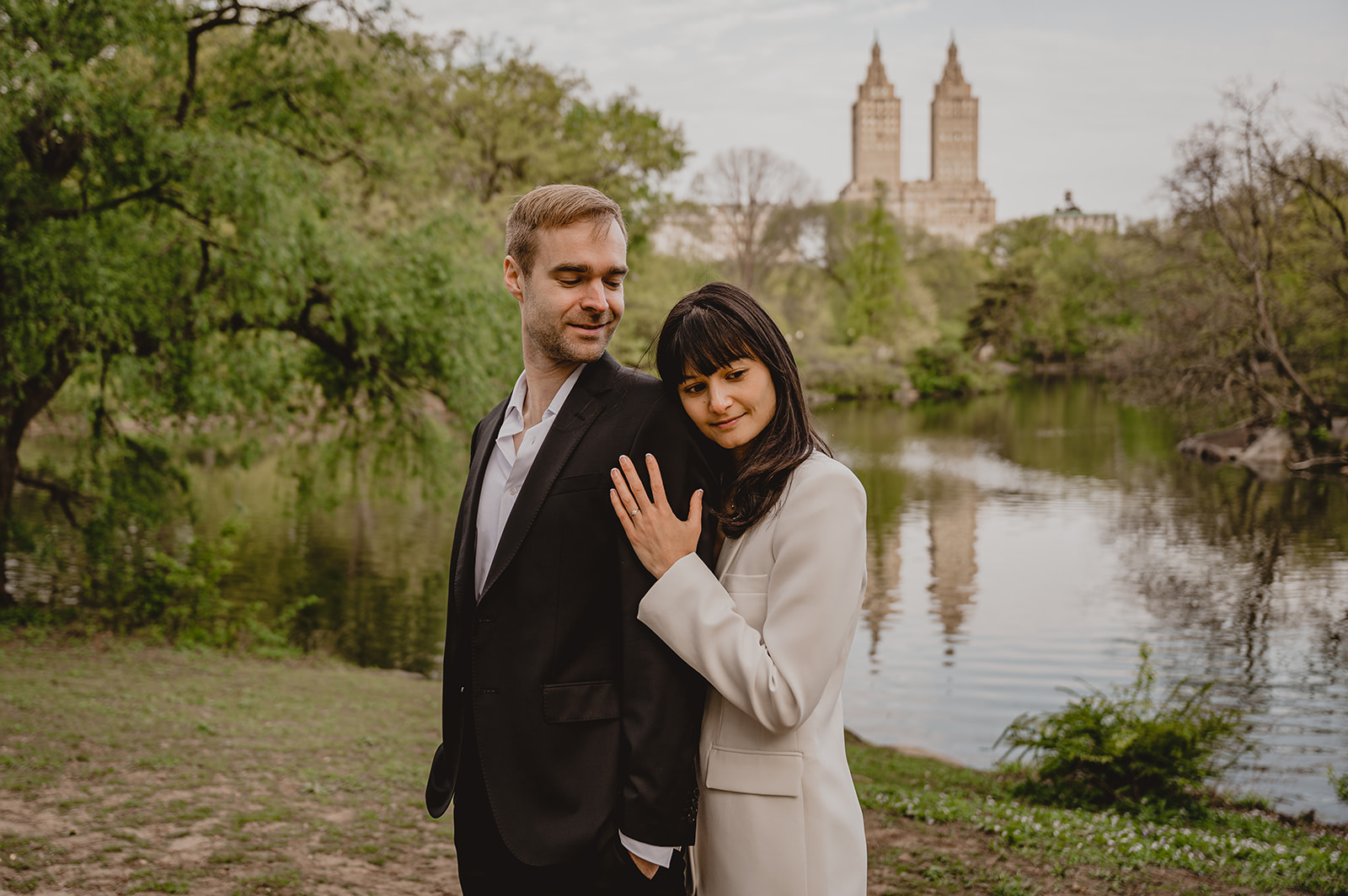 woman hugs man in front of NYC skyline in Central Park