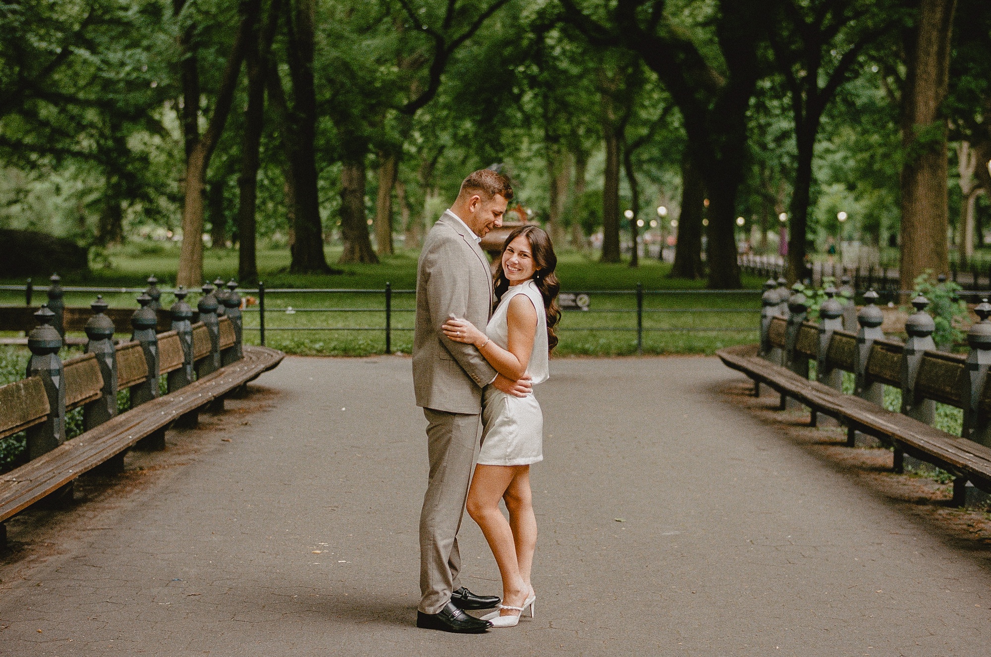 man and woman pose in walkway at Central Park