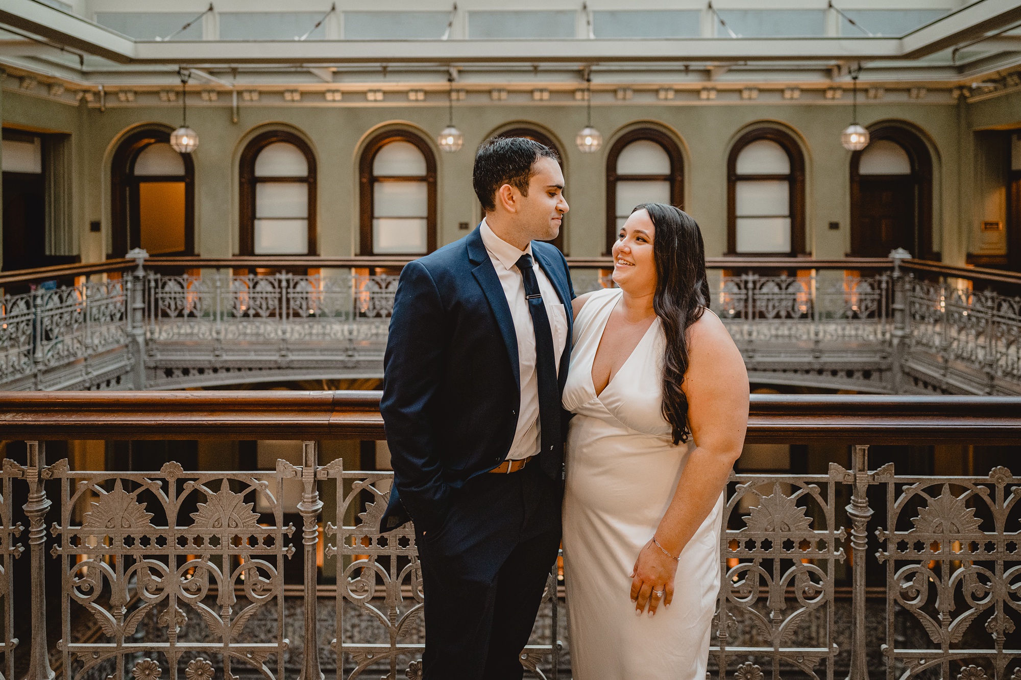 engaged couple hug on balcony of the Beekman Hotel