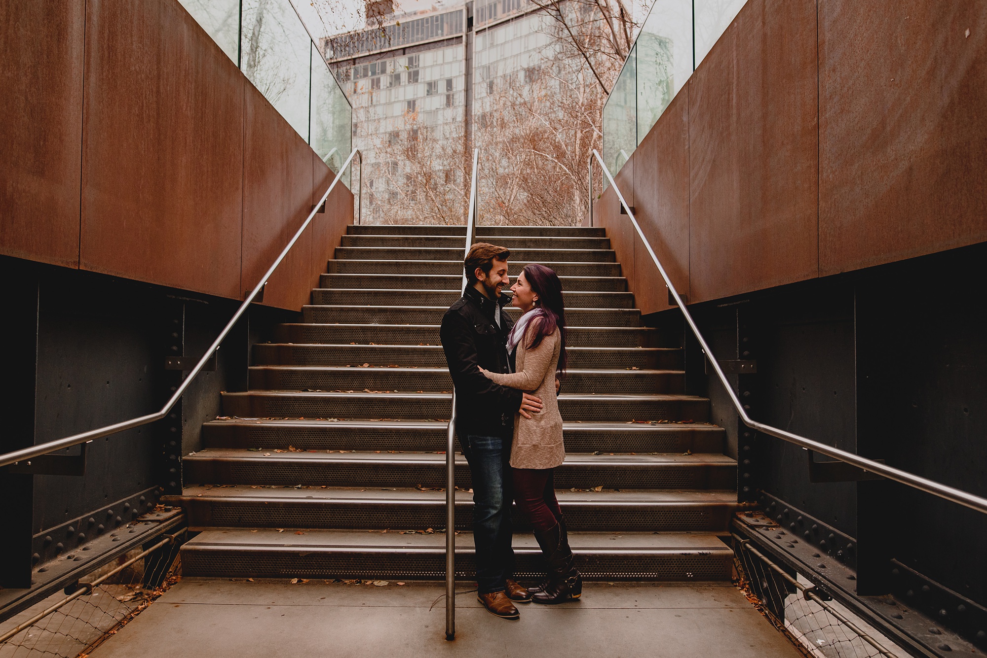 man and woman stand at bottom of stairs at the High Line
