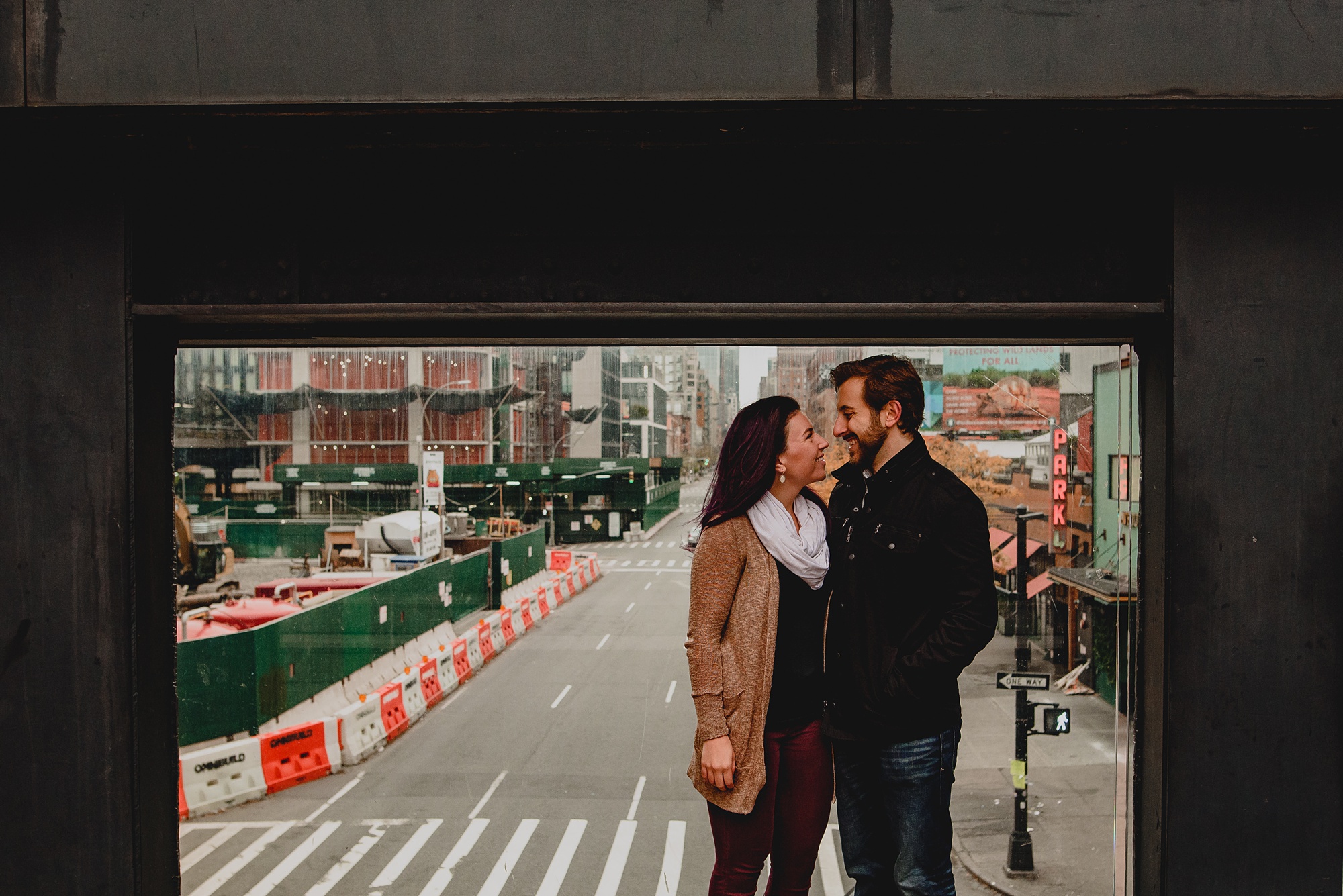 man and woman hug in front of streets in NYC
