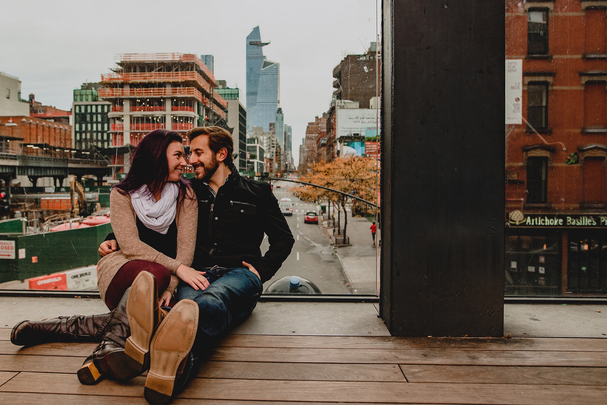 engaged couple sits on the High Line in NYC