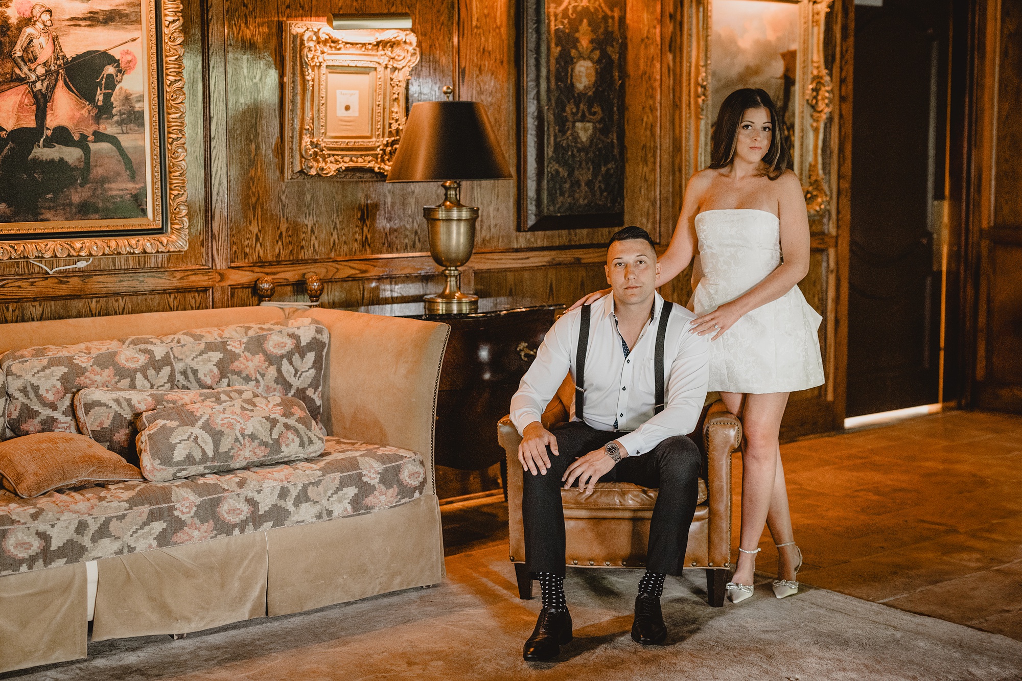 woman stands behind man in chair inside the library at the Ashford Estate