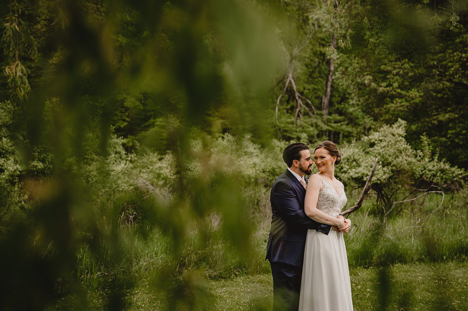 man and woman hug in field at the Reserve at Perona Farms