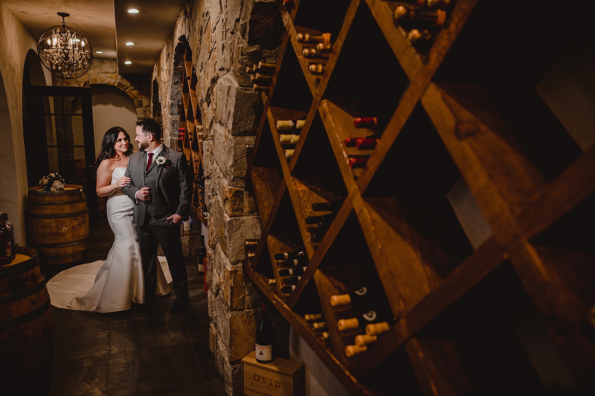 couple hugs in wine cellar in New Jersey venue