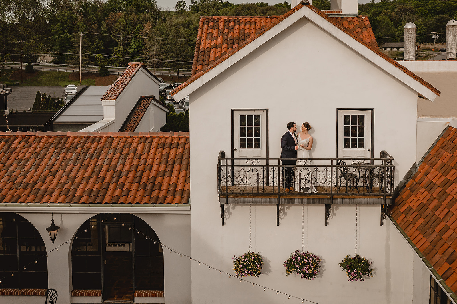 man and woman stand on the balcony of the Reserve at Perona Farms