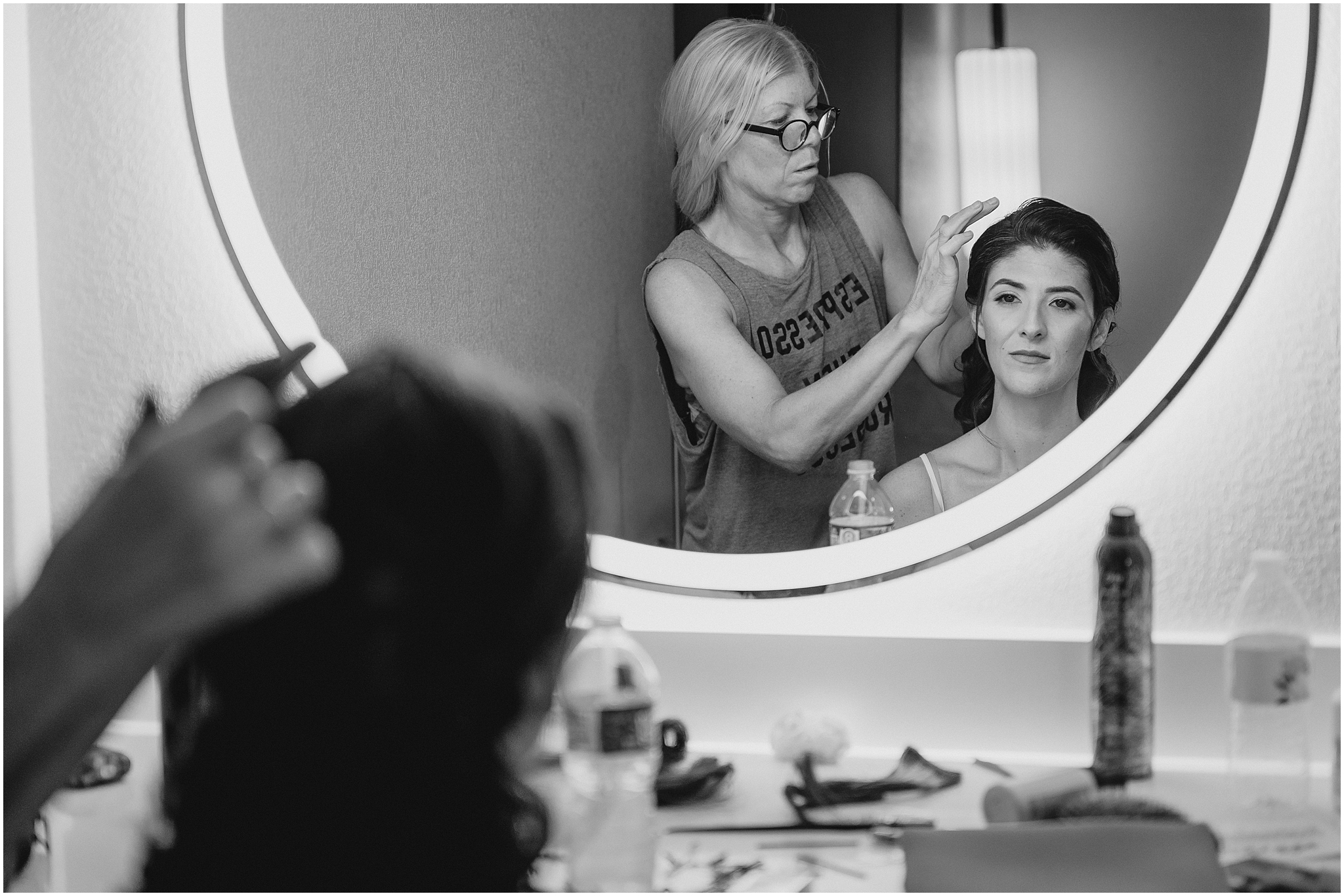 woman helps bride with hair in New Jersey hotel