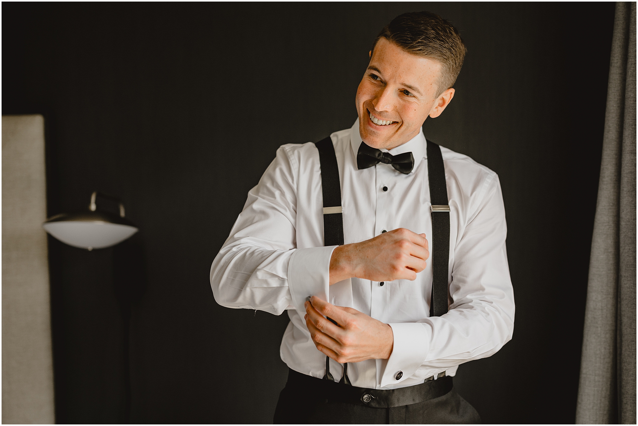 groom adjusts black cufflinks before wedding day in New Jersey