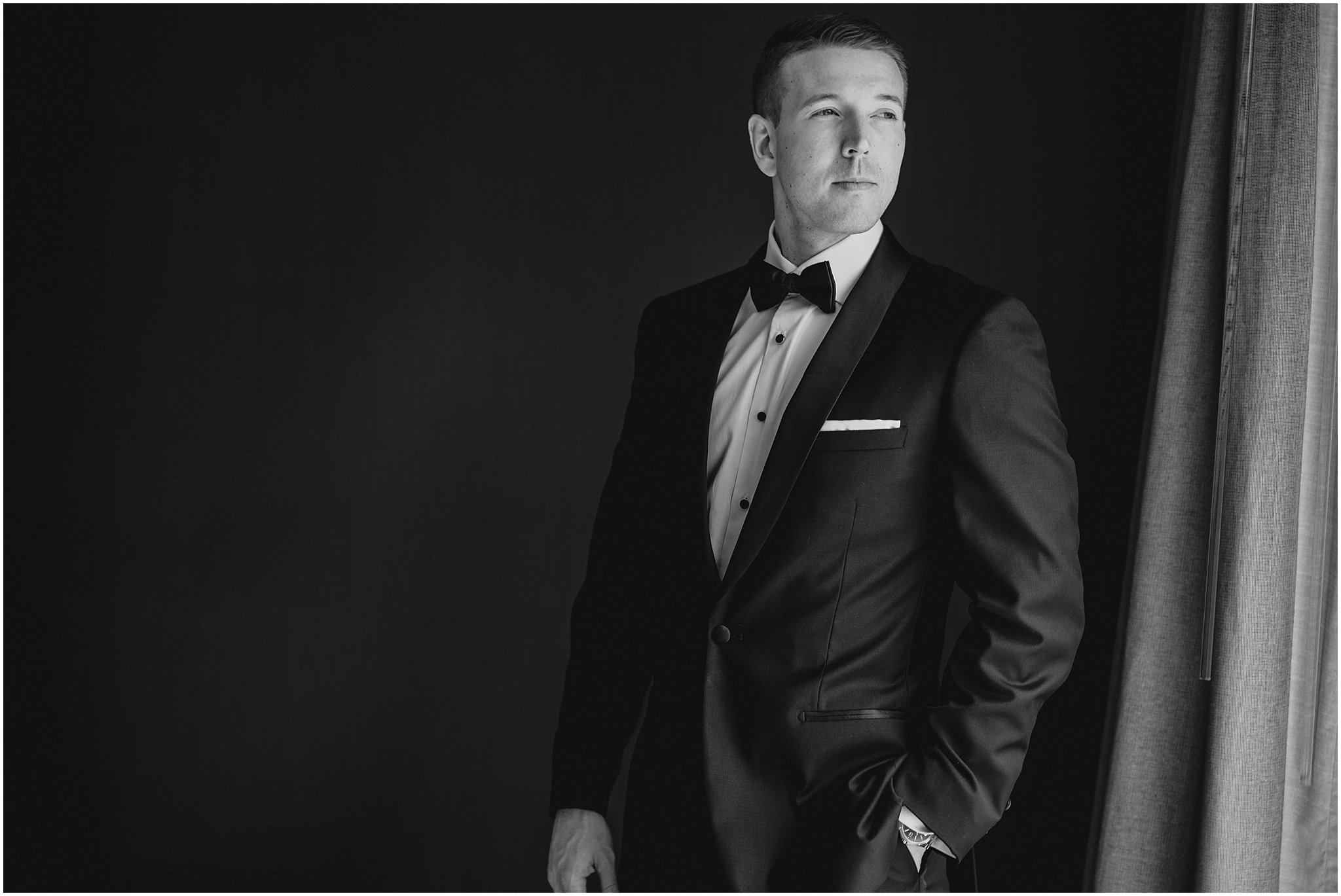 groom stands with hands in pockets of suit at the Conservatory in New Jersey