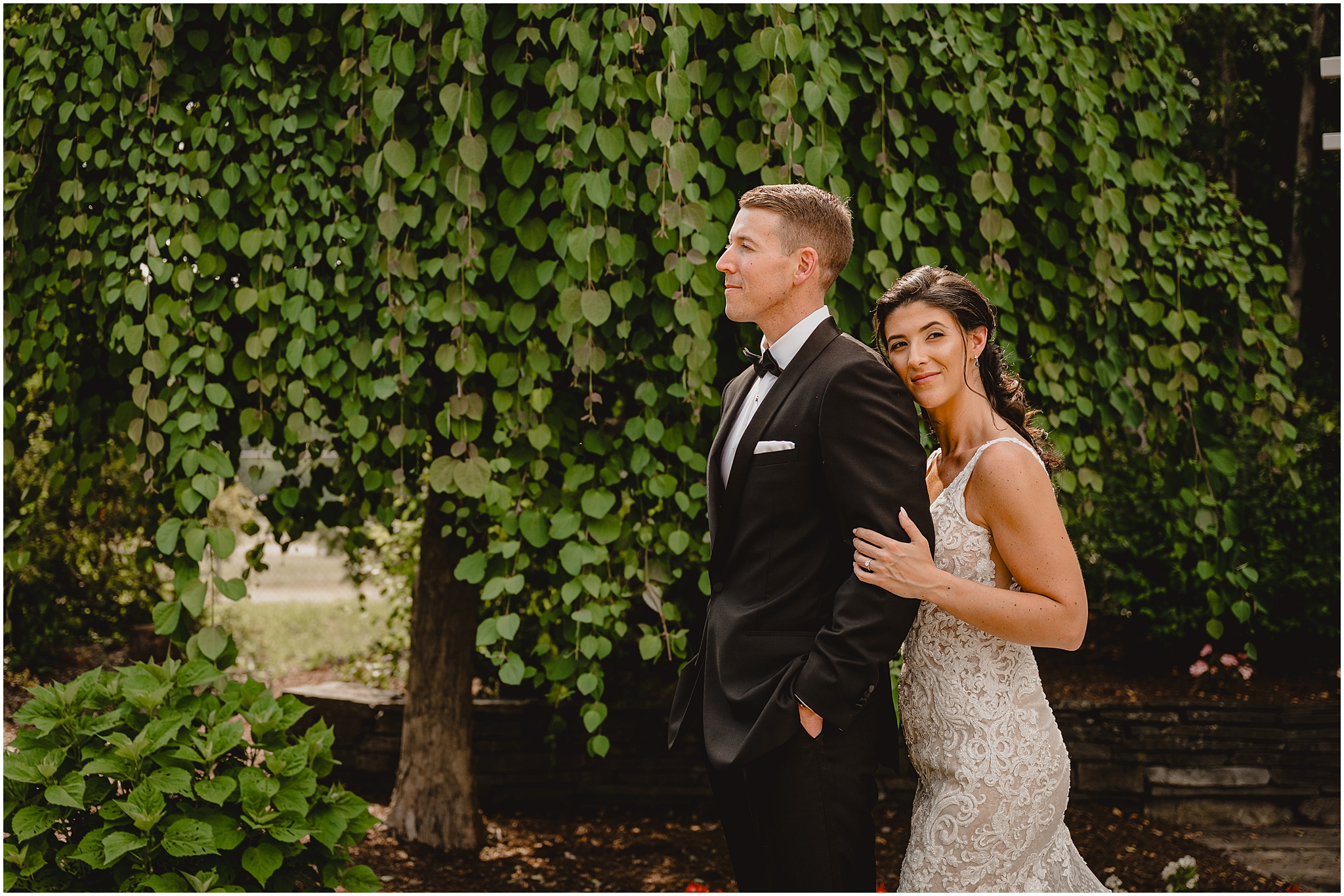 bride leans on groom's back during portraits at the Conservatory at Sussex County Fairgrounds