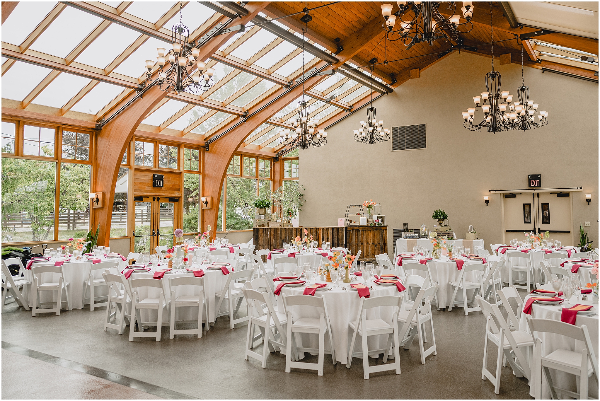 reception at the Conservatory at Sussex County Fairgrounds with peach and pink details for place settings