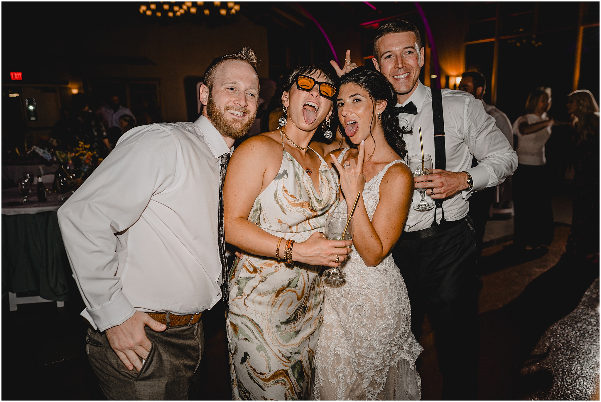 bride and groom pose with guests on dance floor during NJ wedding reception