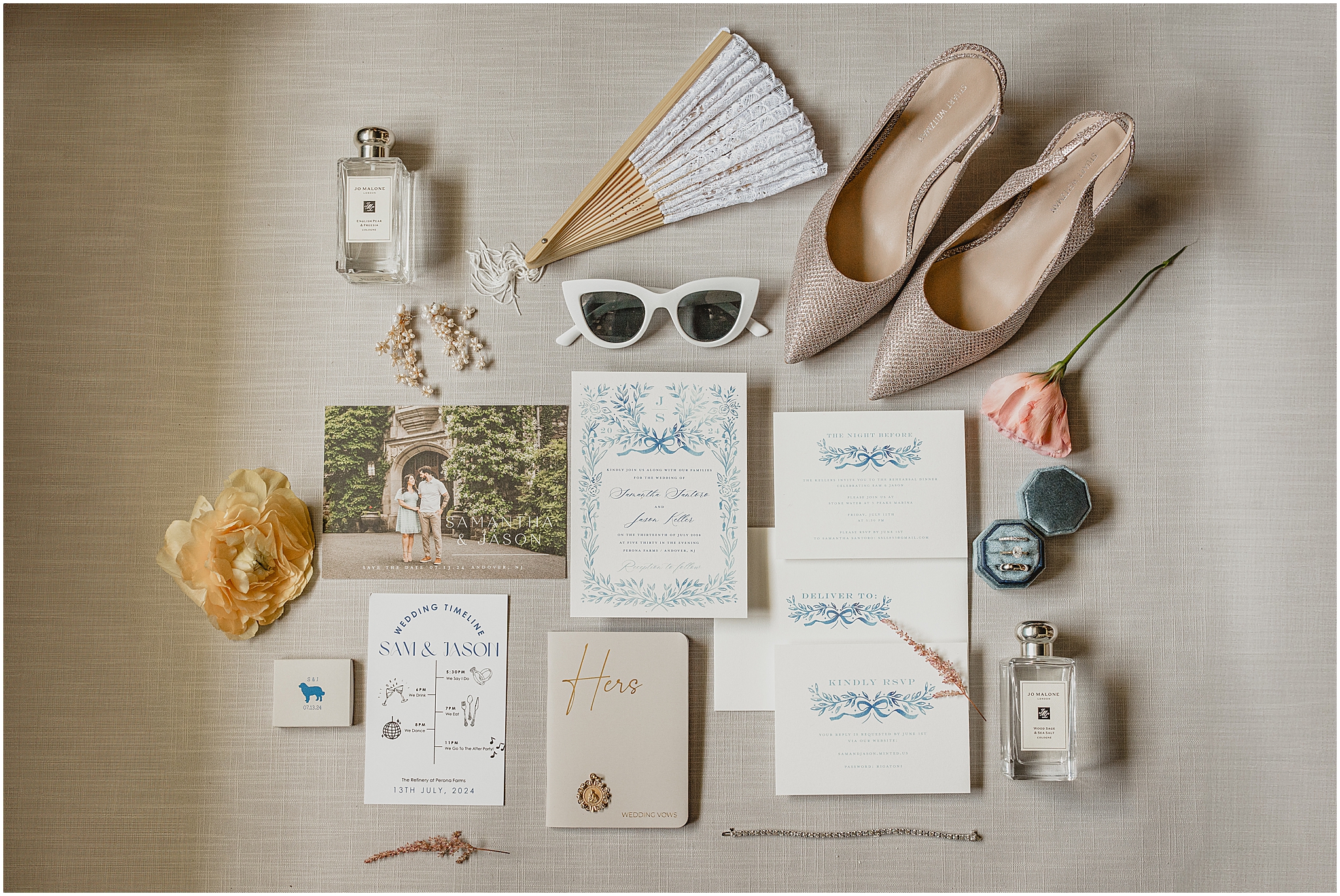 elegant blue and white invitation suite with bride's shoes, fan, and perfume