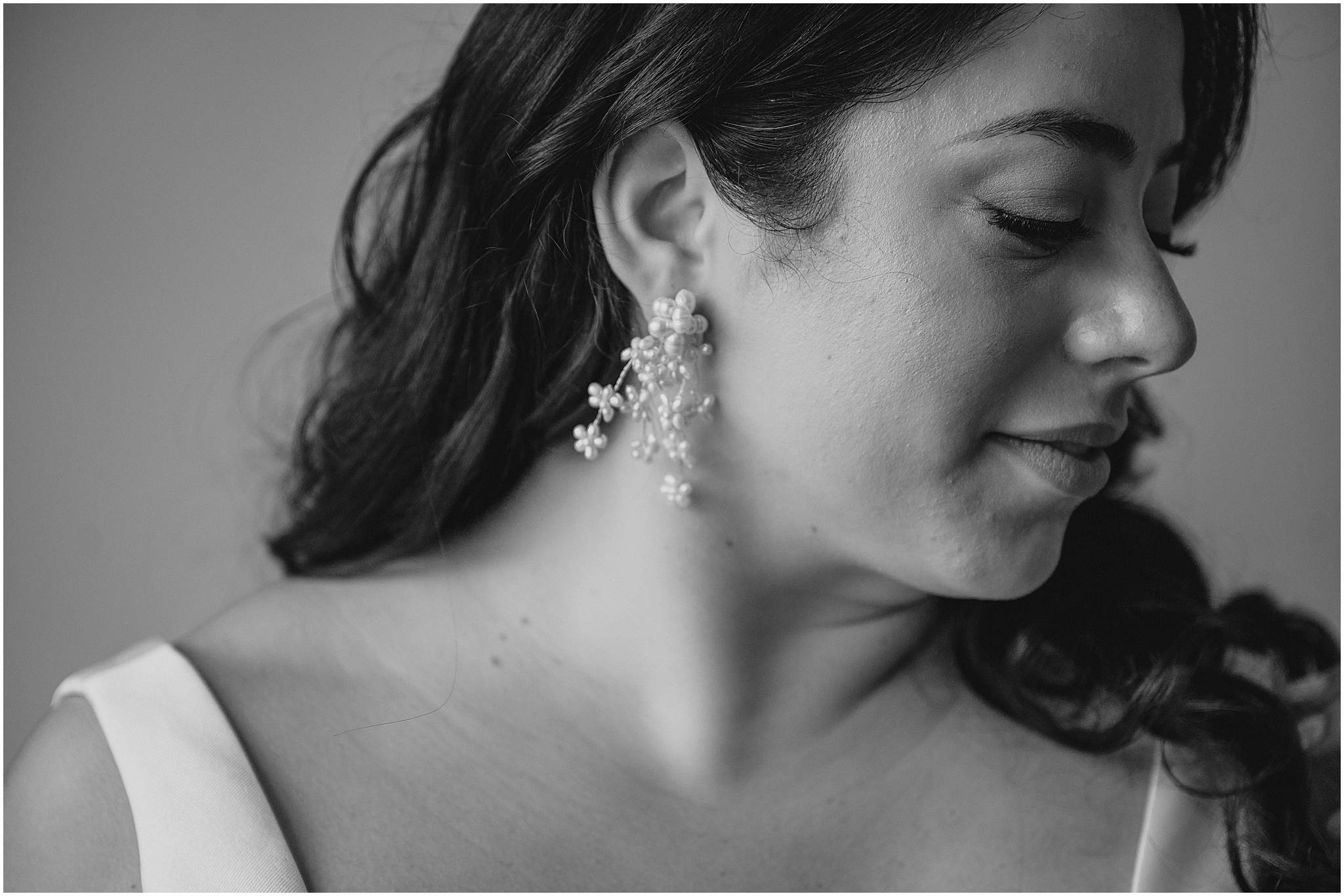 bride looks over shoulder with pearl earring