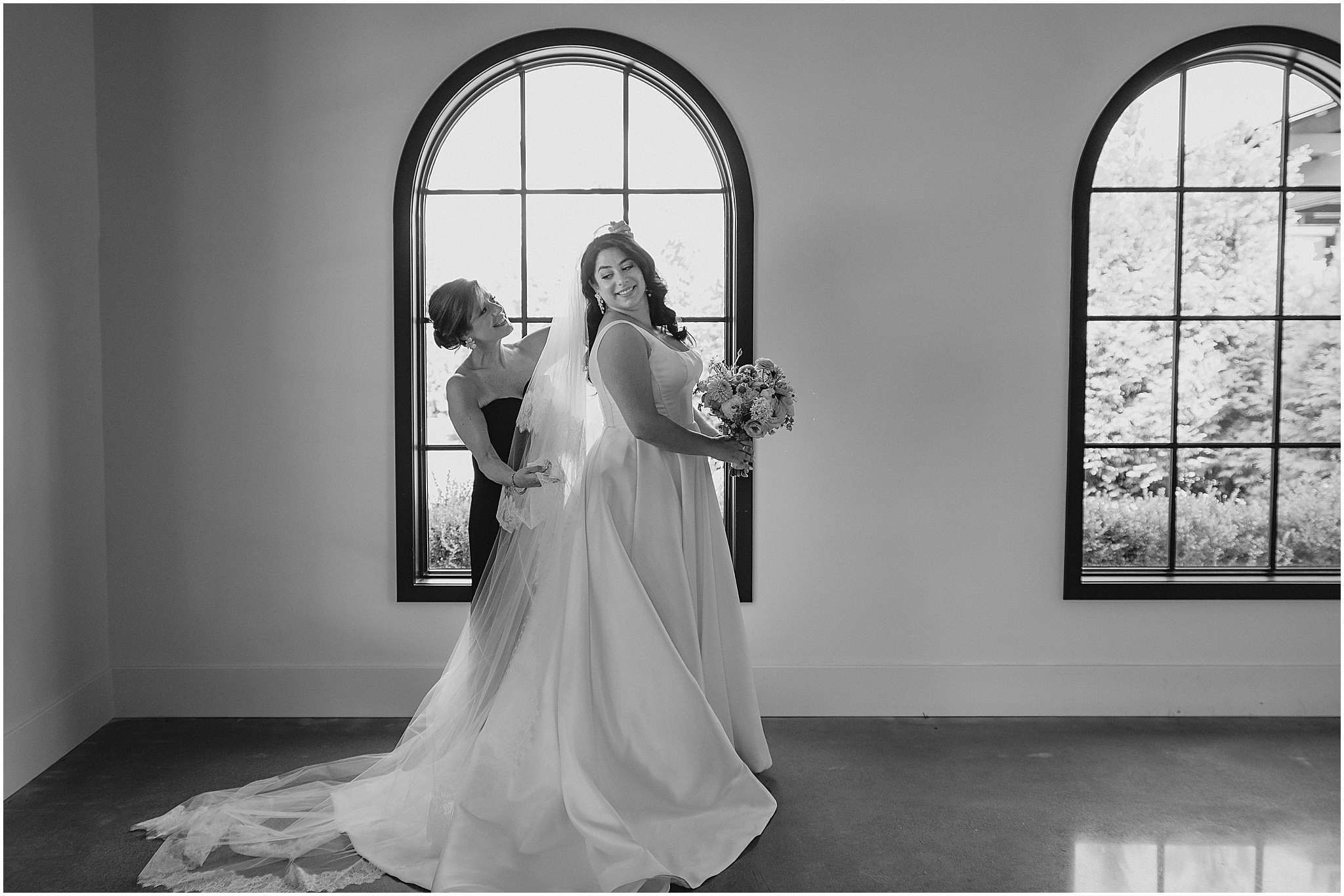 bridesmaid helps place veil for bride inside the Perona Farms Refinery