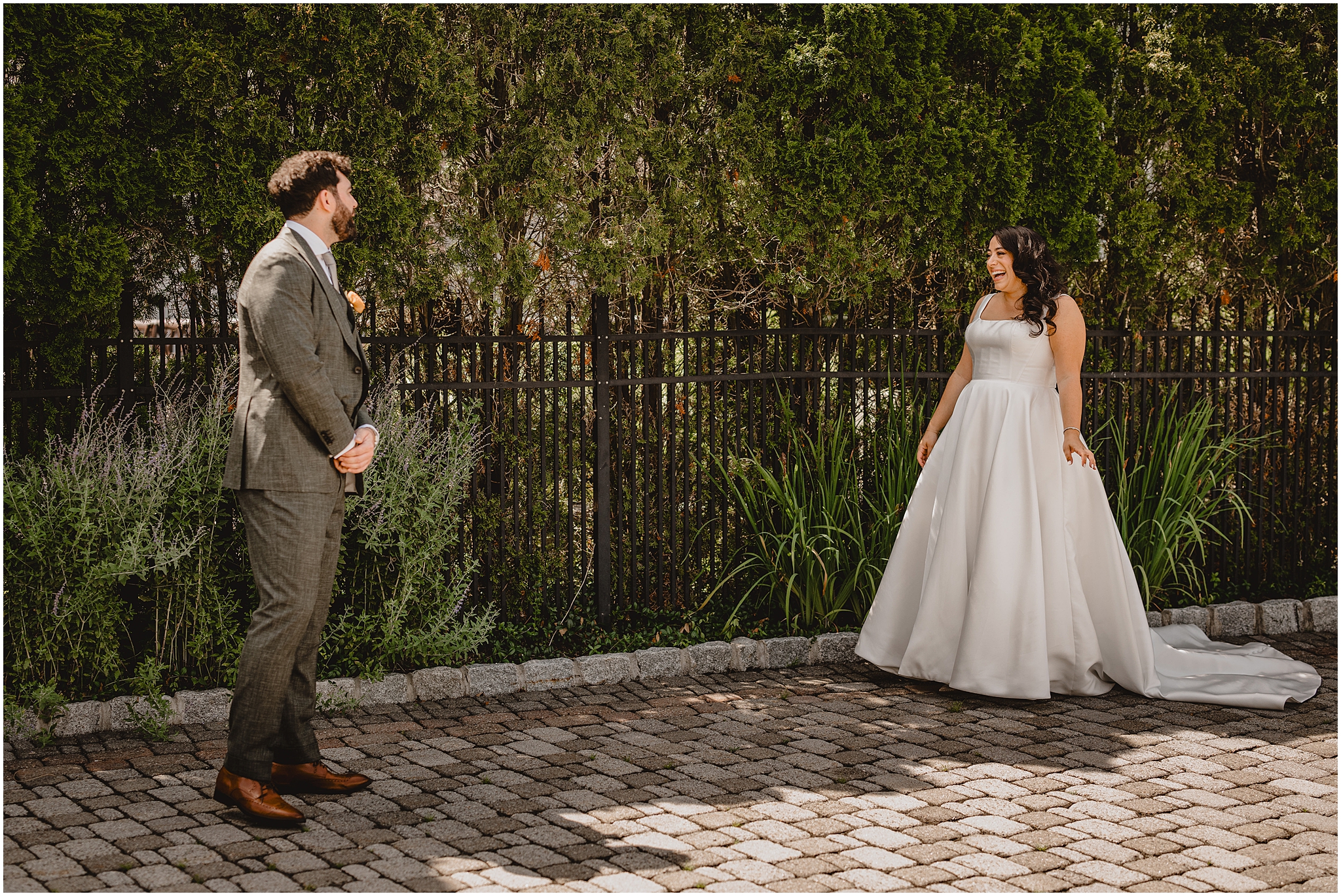 bride grins at groom during first look outside the Perona Farms Refinery