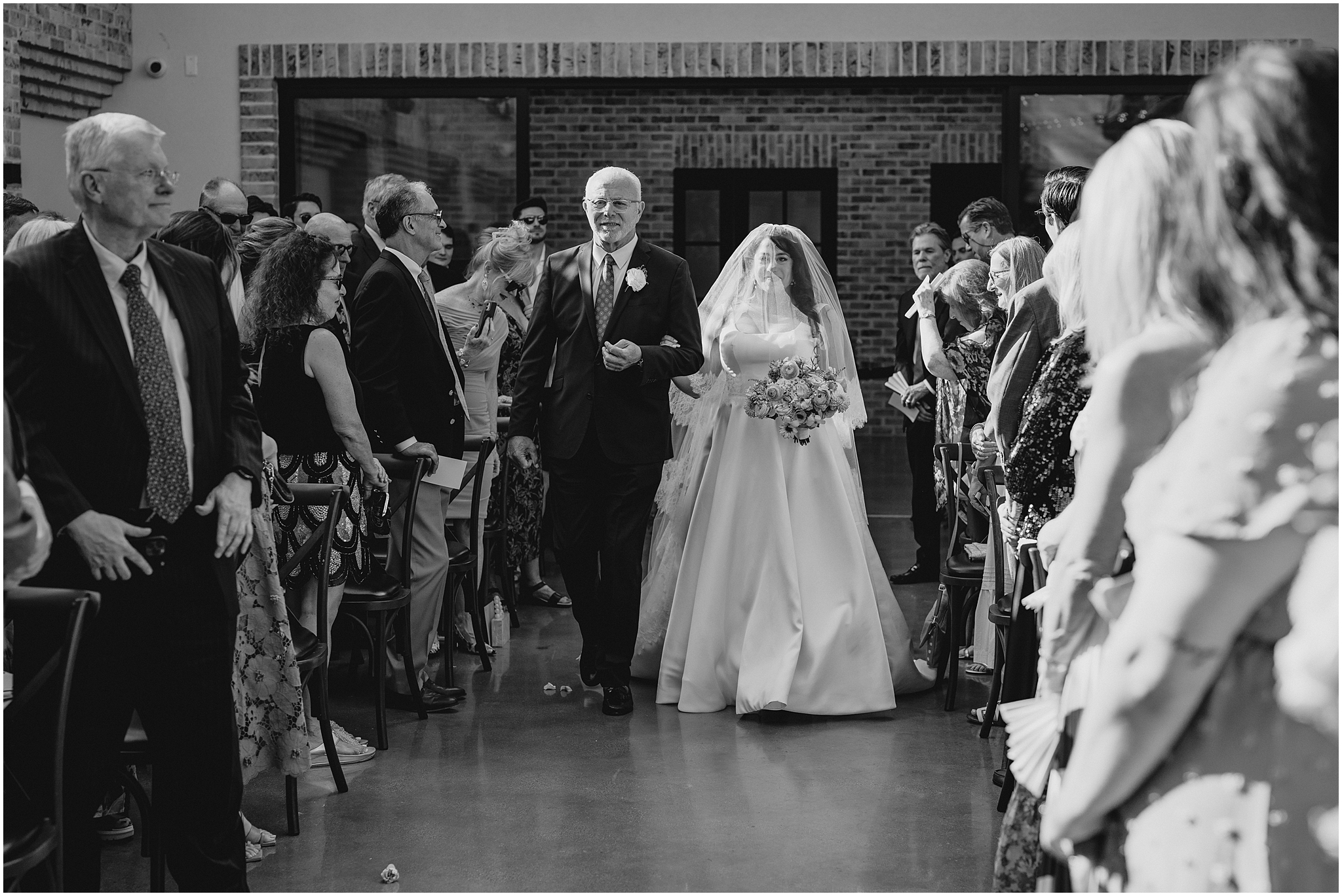 father walks bride down aisle for wedding ceremony outside at the Perona Farms Refinery