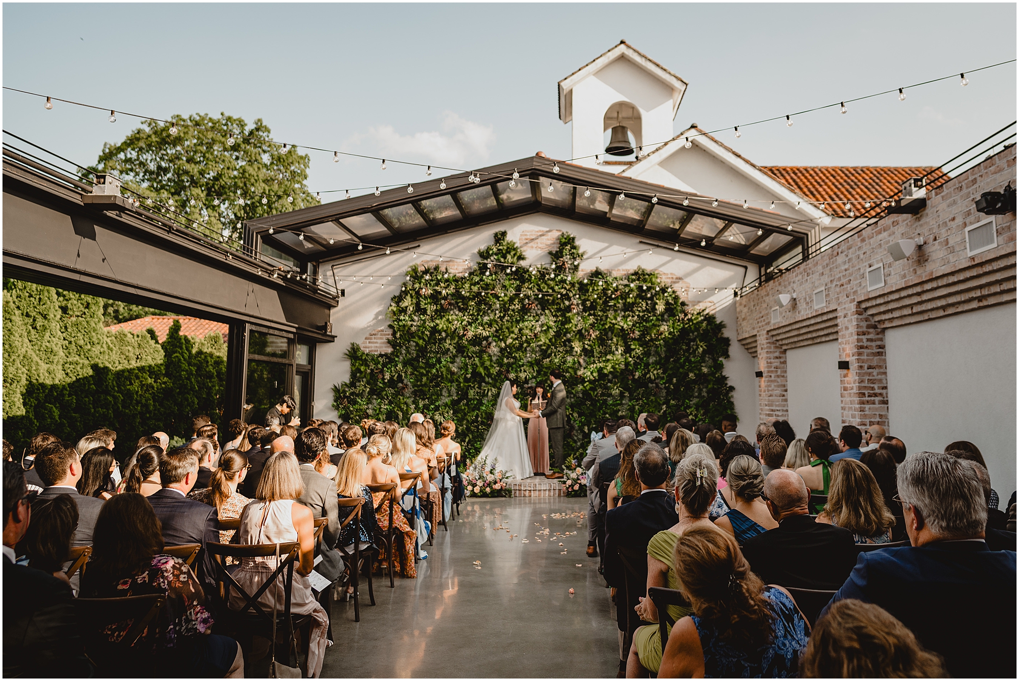 bride and groom exchange vows during summer wedding at the Perona Farms Refinery