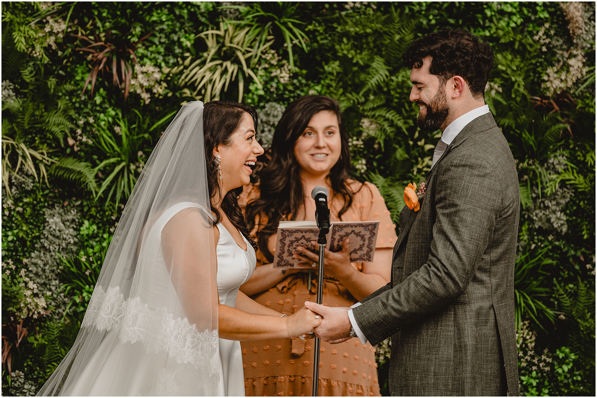 newlyweds laugh during wedding ceremony at the Perona Farms Refinery