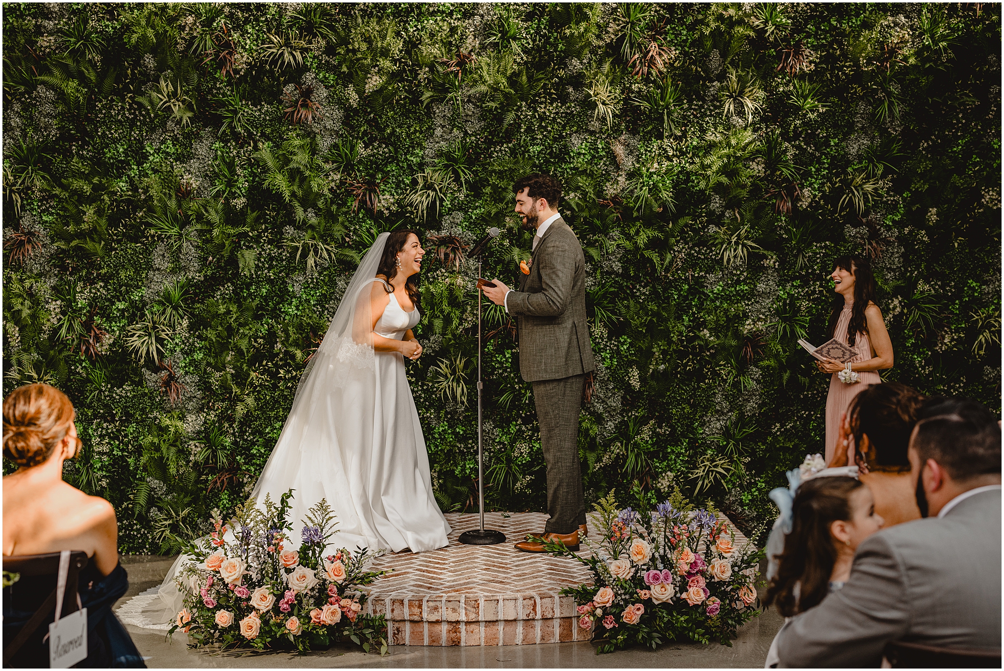 bride laughs during outdoor summer wedding ceremony at the Perona Farms Refinery