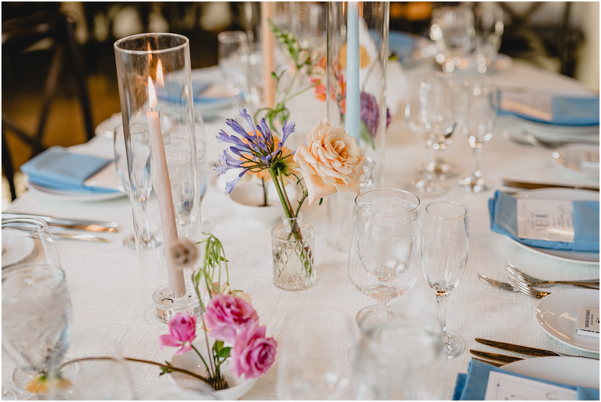summer wedding reception place setting with pastel wildflower centerpieces 