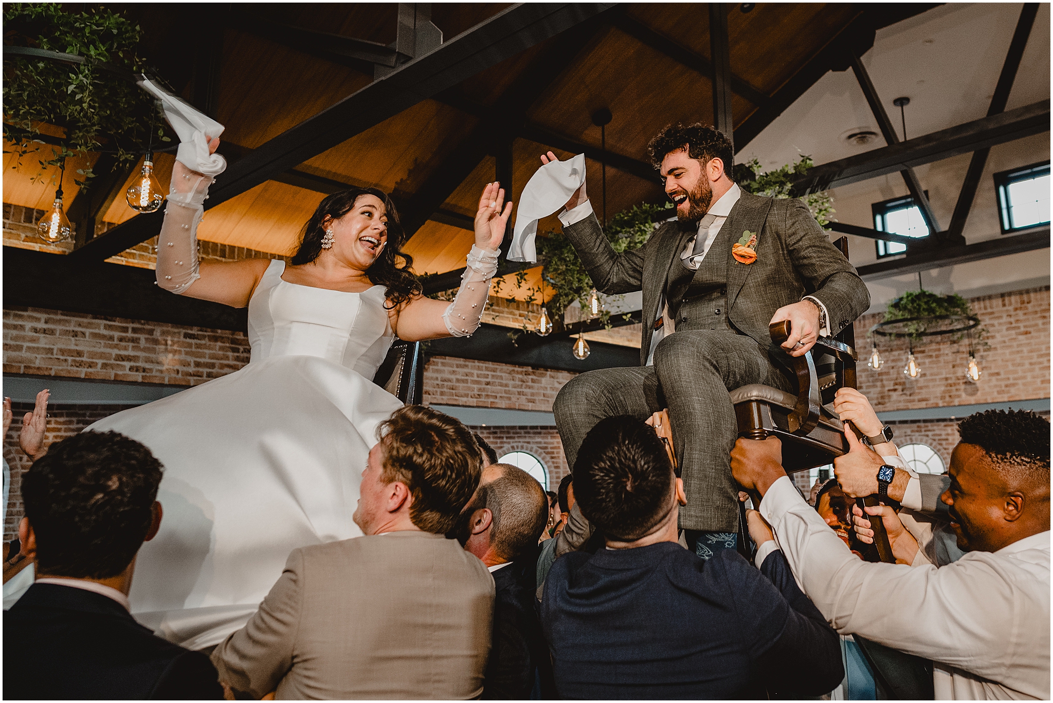 guests lift up bride and groom during hora for NJ wedding reception 