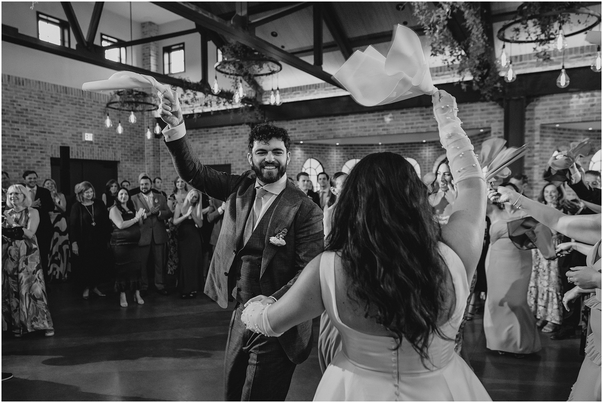 newlyweds dance twirling napkins in the air at the Perona Farms Refinery