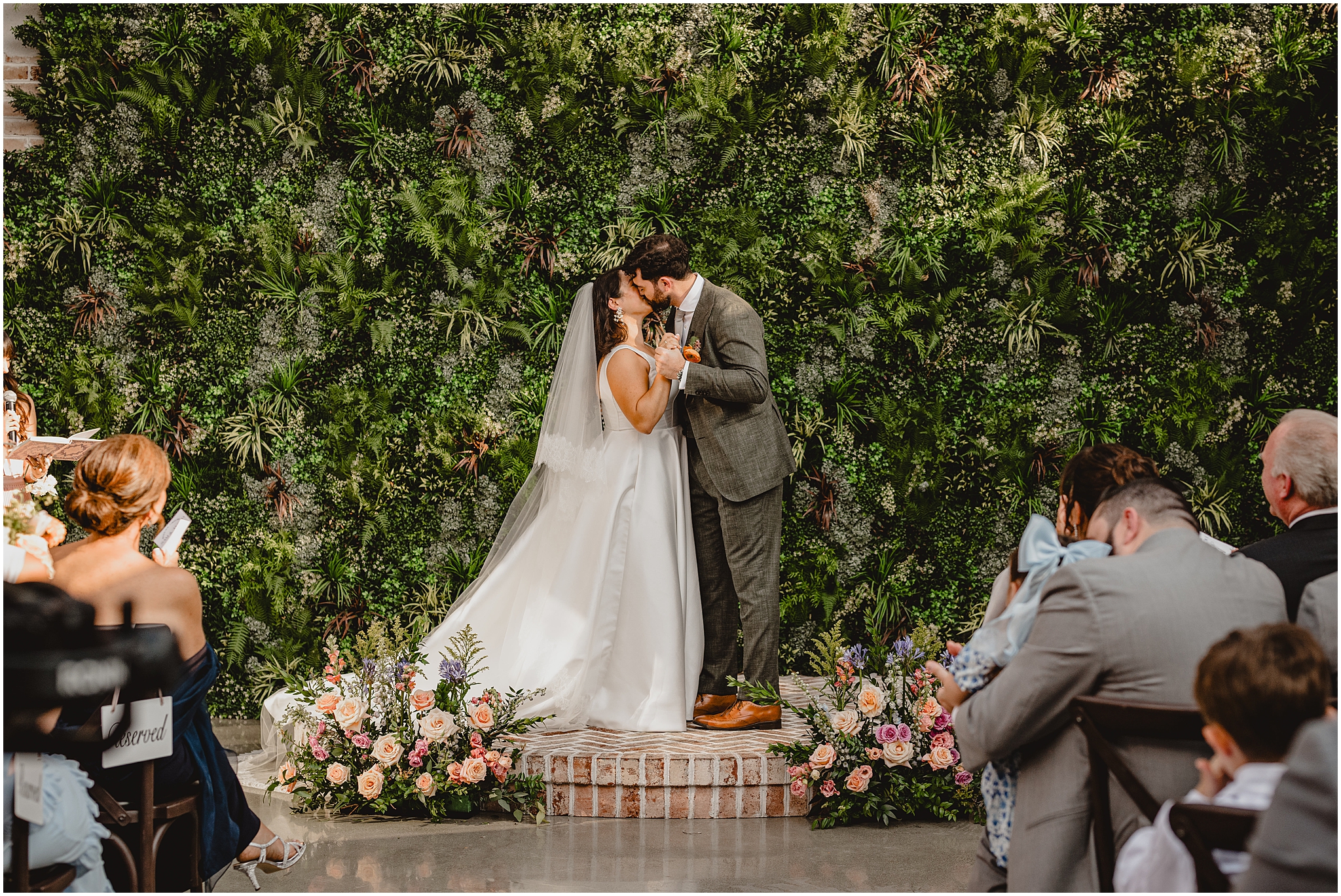 newlyweds kiss during outdoor wedding ceremony at the Perona Farms Refinery