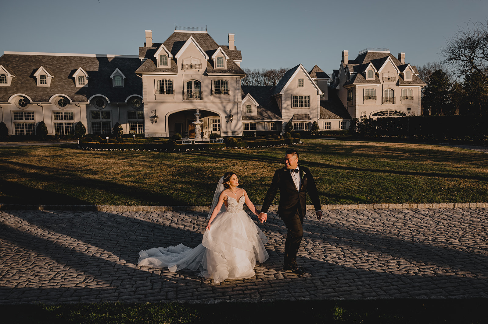 newlyweds walk outside estate home in New Jersey