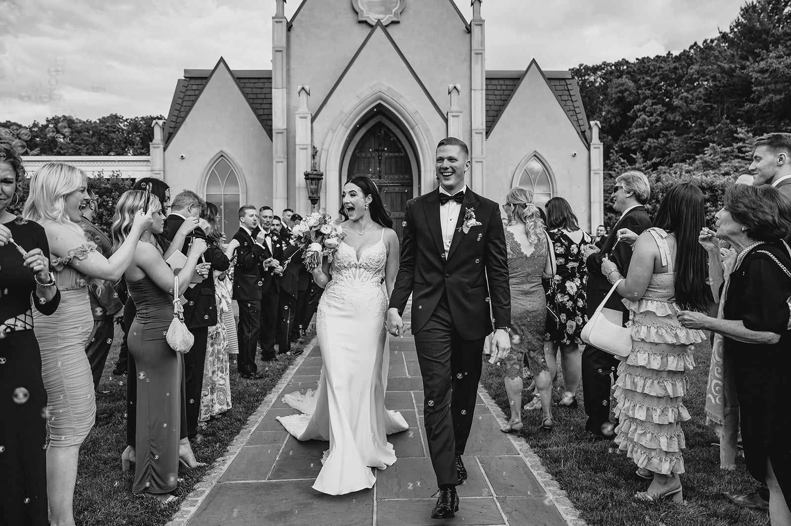 bride and groom hold hands walking away from chapel at Park Chateau Estate