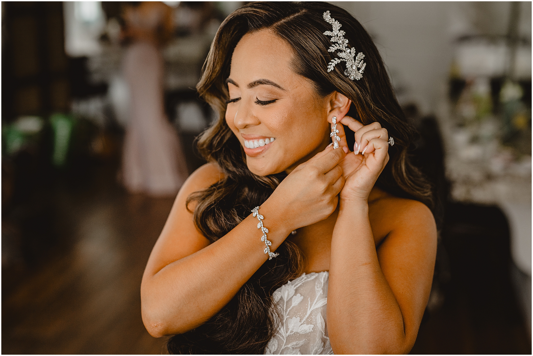 bride shows off diamond drop earrings smiling as she adjusts at the Refinery at Perona Farms