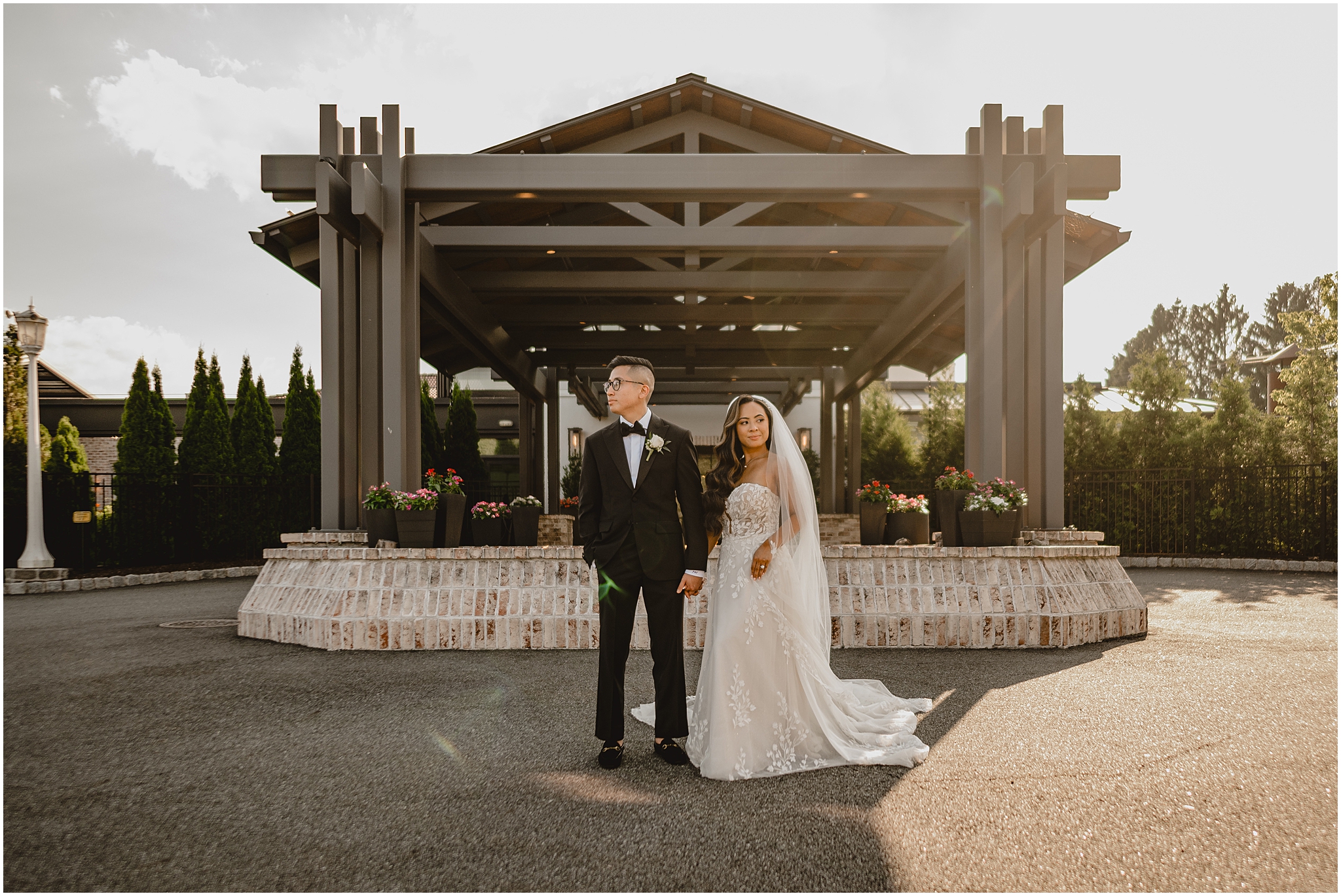 bride and groom hold hands in front of awning at the Refinery at Perona Farms
