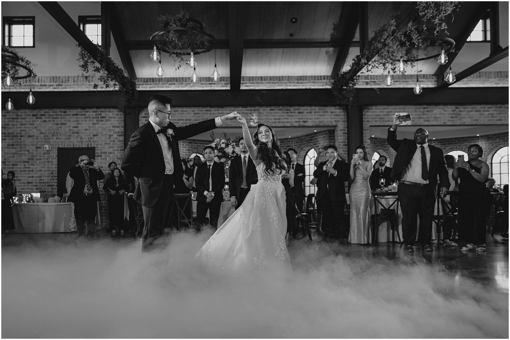 groom twirls bride for first dance with fog around them during Andover NJ wedding reception