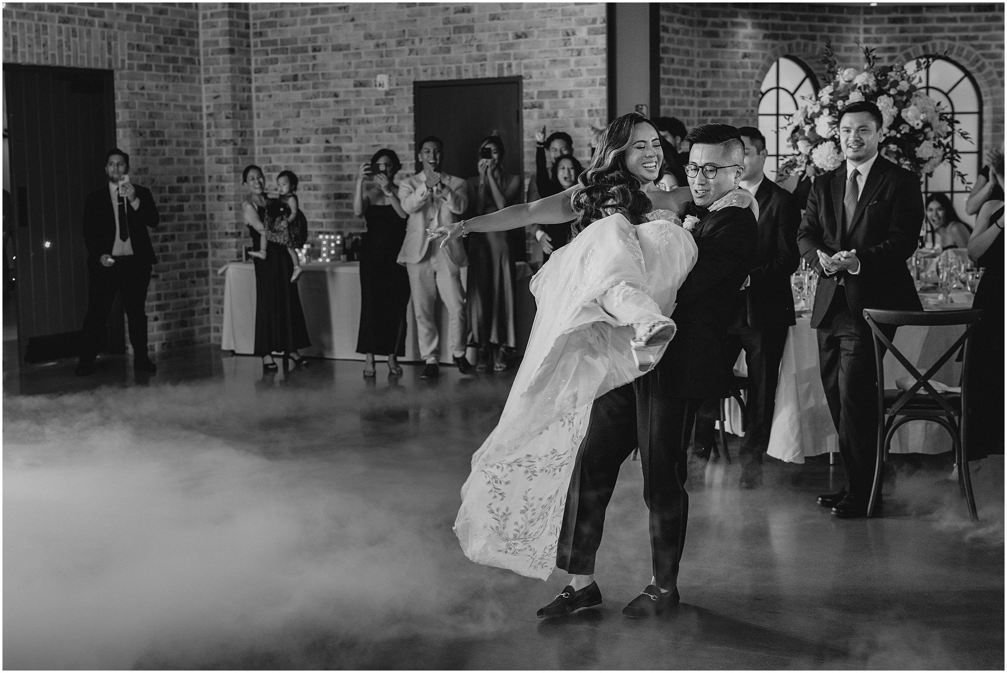 groom lifts up bride twirling her on dance floor during Andover NJ wedding reception