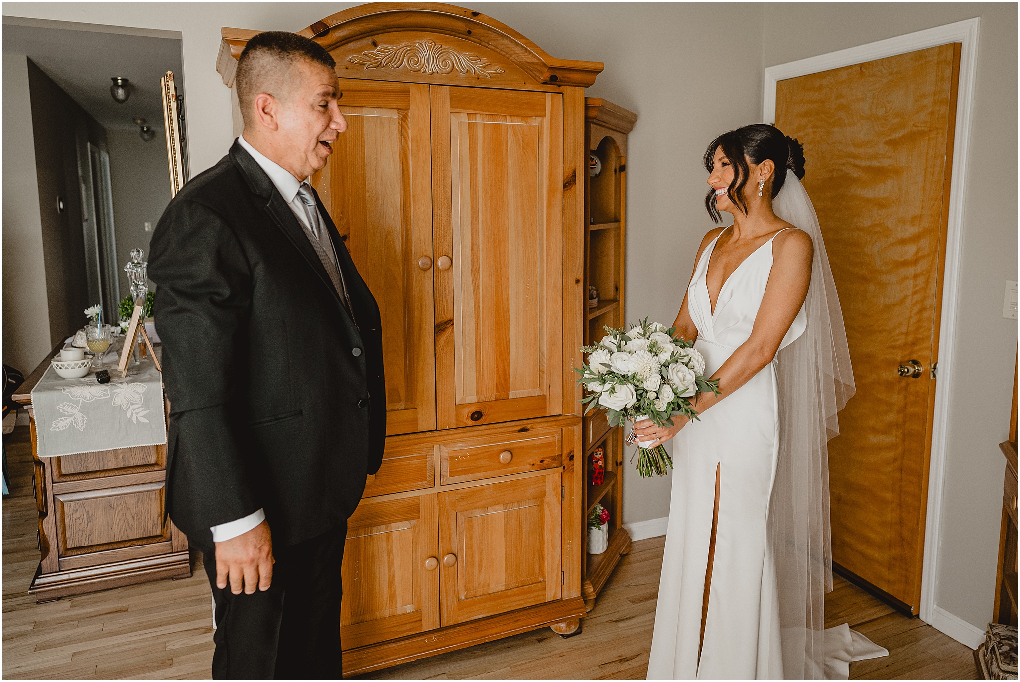 bride and dad have first look in bedroom during NJ wedding day