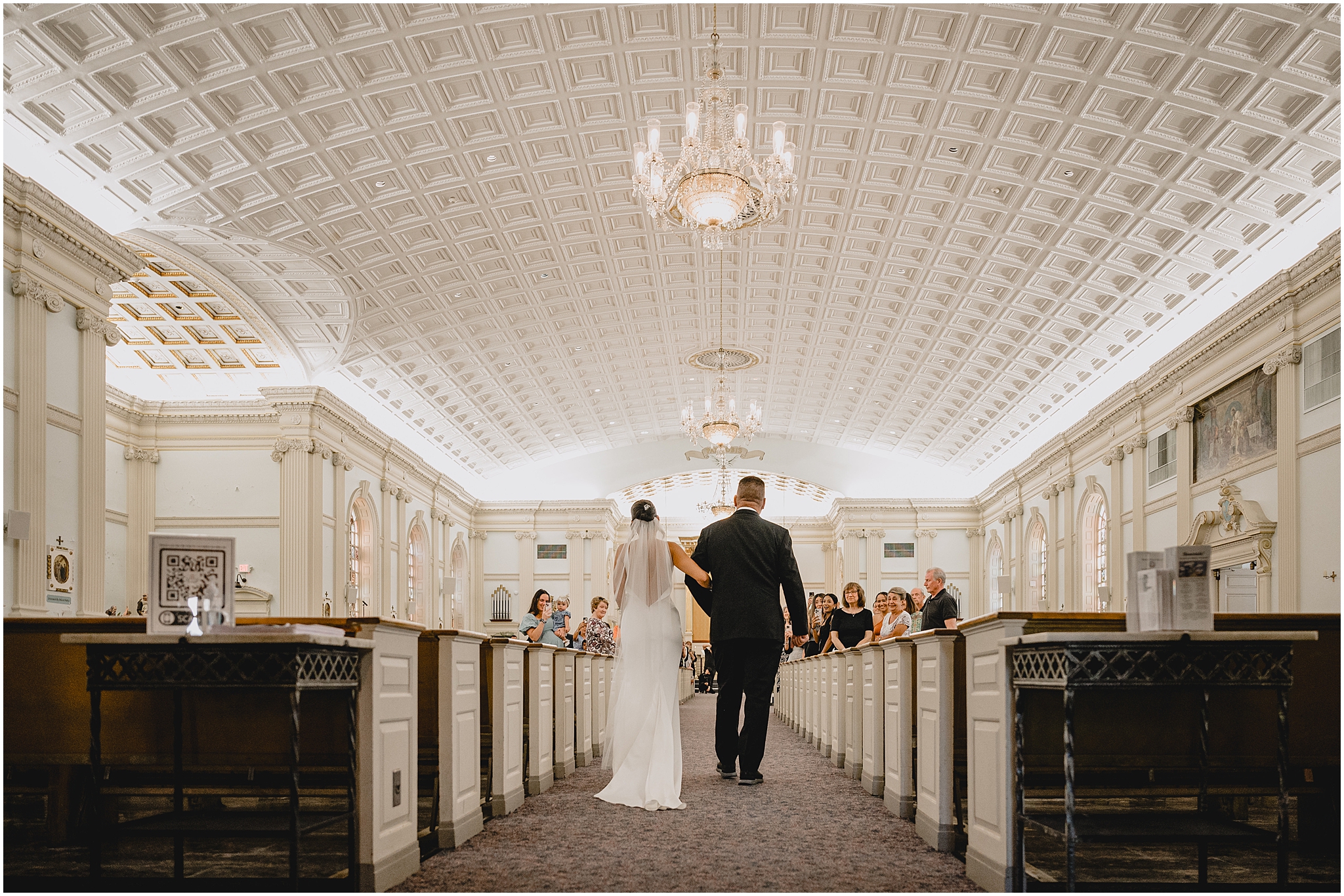 father escorts bride down aisle in church with textured ceiling in jersey City